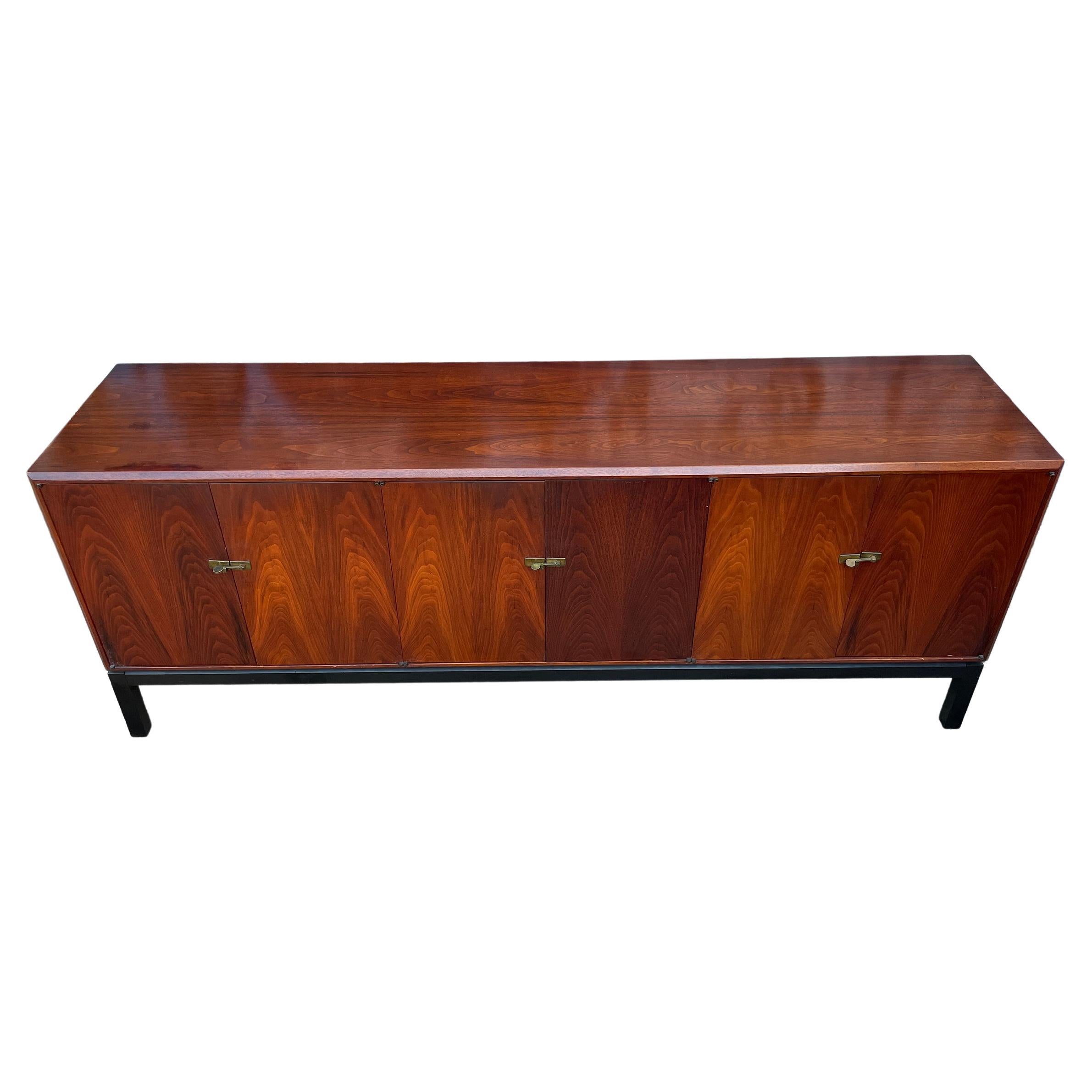Mid-Century Modern 3 drawer - 6 door credenza in walnut. All Original Vintage condition - beautiful grain walnut doors and top. shows little wear - Solid brass flip handle locks. 3 drawers inside center All drawers slide smooth and clean inside.