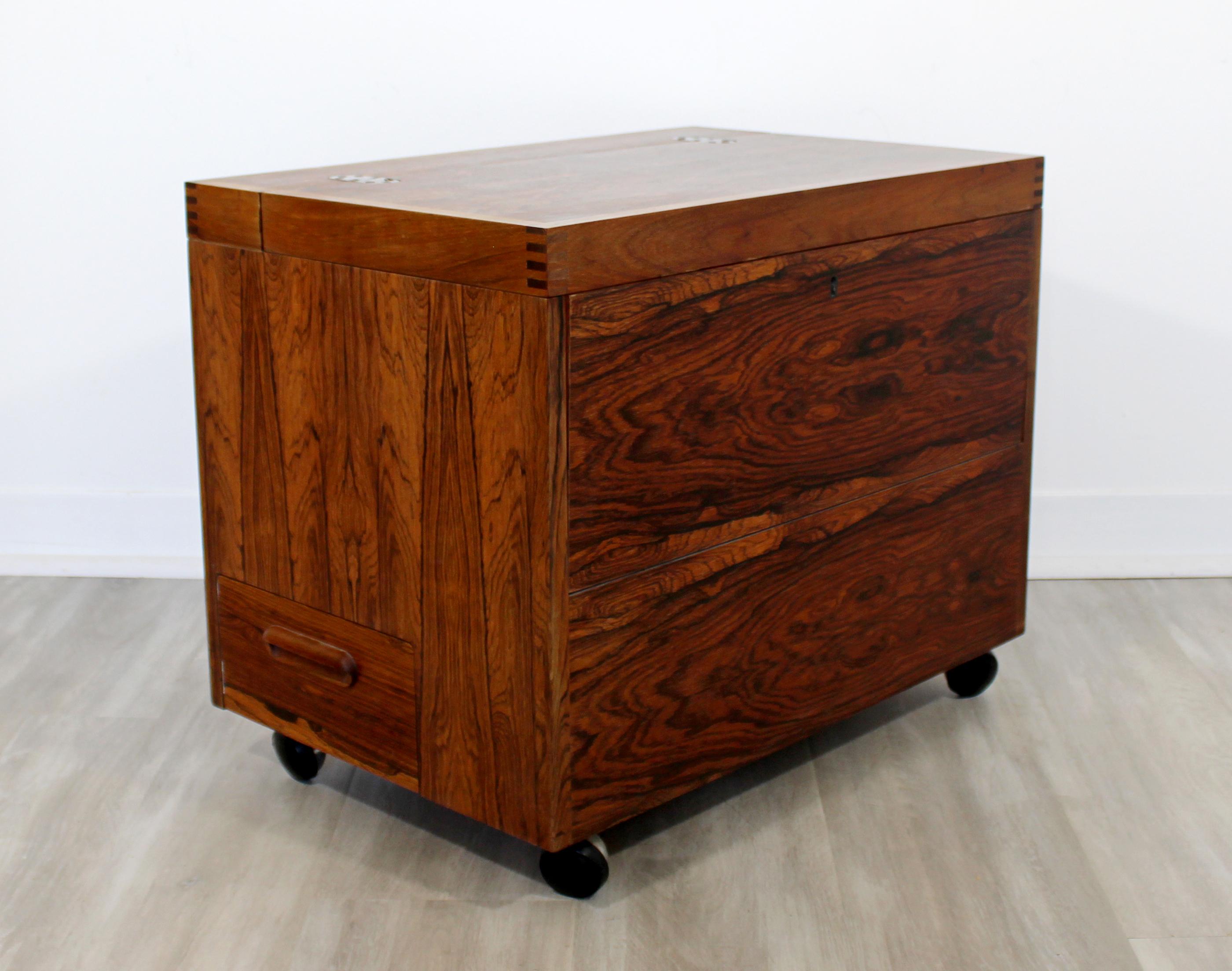 For your consideration is an incredible, cube mini bar, or side table with compartments, made of rosewood and with brass hinges, on casters, designed by Rolf Hesland and crafted by Haug Snekkeri, circa the 1960s. In very good vintage condition. The