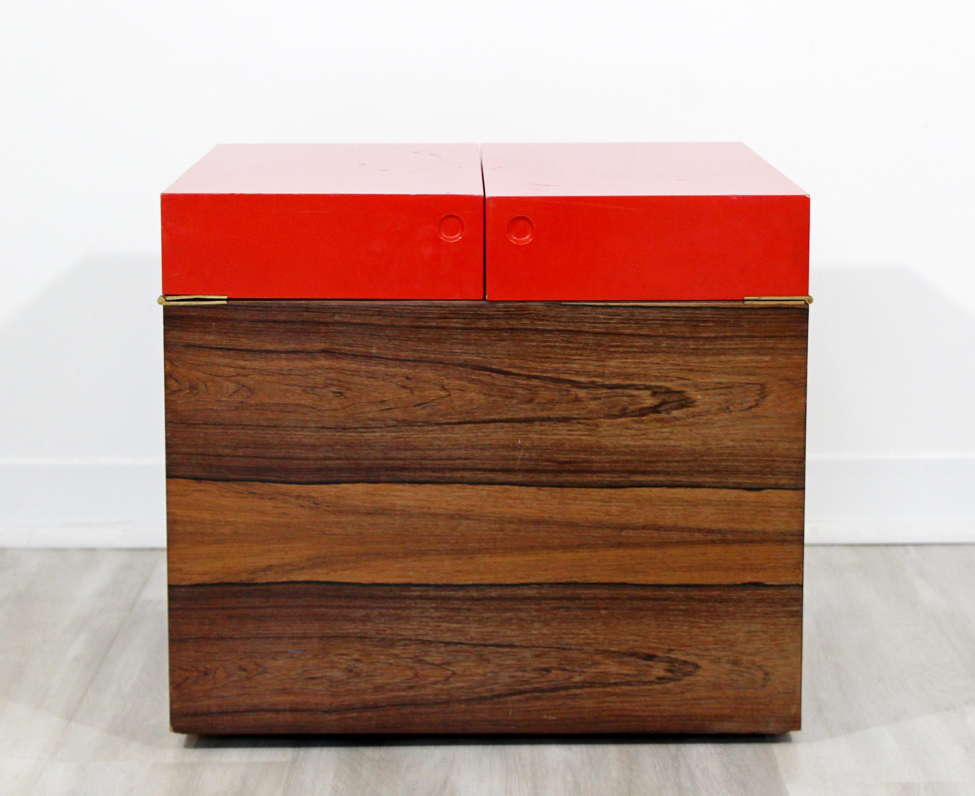 For your consideration is a fantastic, cube mini bar, made of walnut and with a red top, on casters, in the style of Rolf Hesland, circa 1960s. In good vintage condition. The dimensions are 19.75