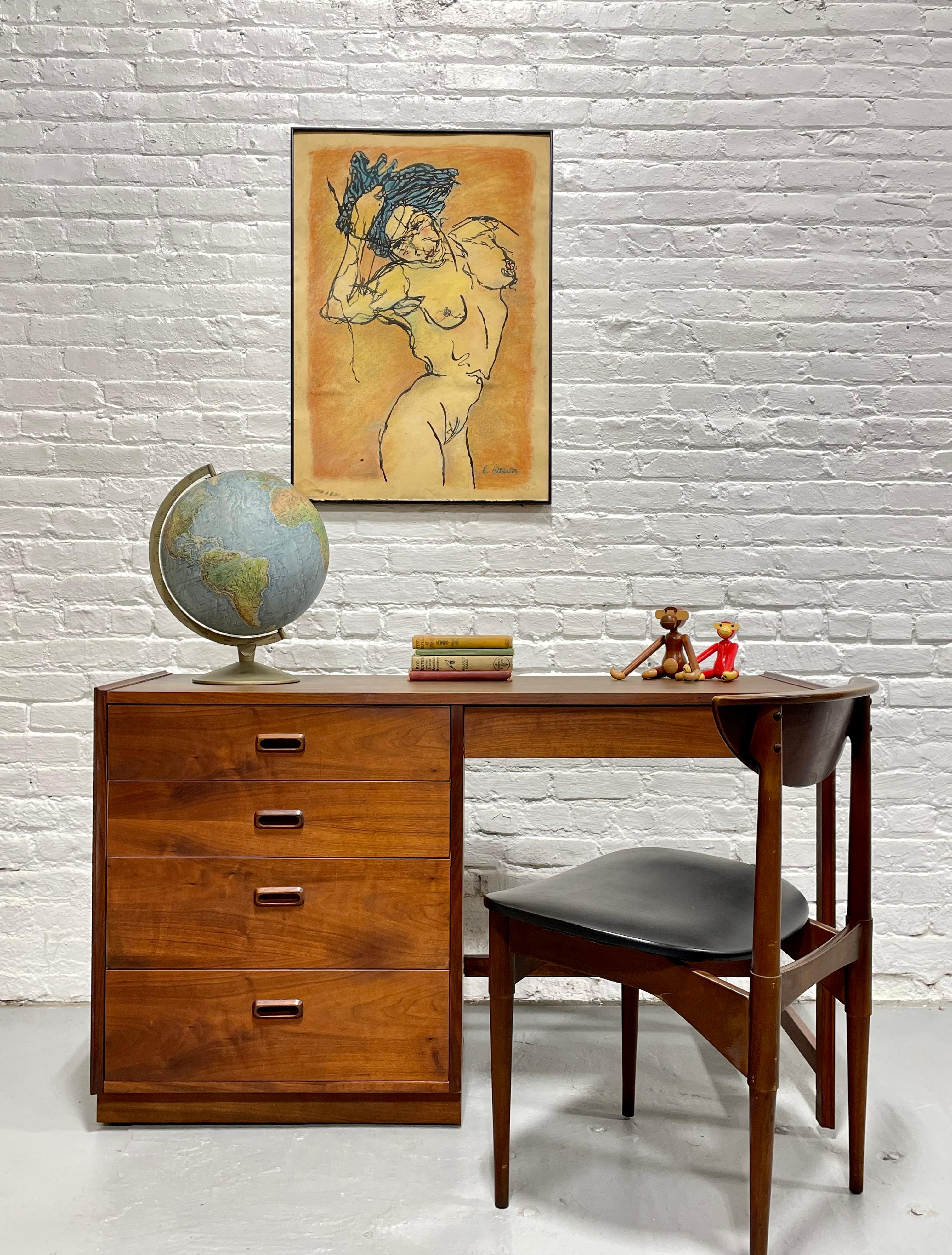 Mid Century Modern Walnut Desk by Founders Furniture Co., c. 1960's. Featuring a total of five dovetailed drawers with sculpted hand pulls and a laminate woodgrain tabletop, perfect for withstanding the wear and tear of a work surface. The back is