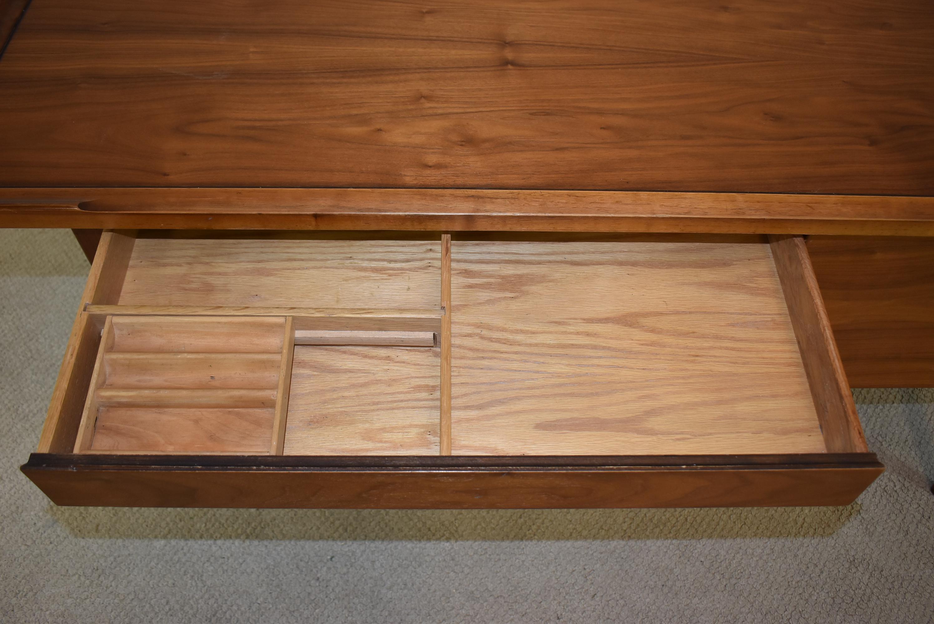 Mid-Century Modern walnut desk designed by Kipp Stewart for Drexel. Wide desk drawer in center with one deep single file drawer. 60