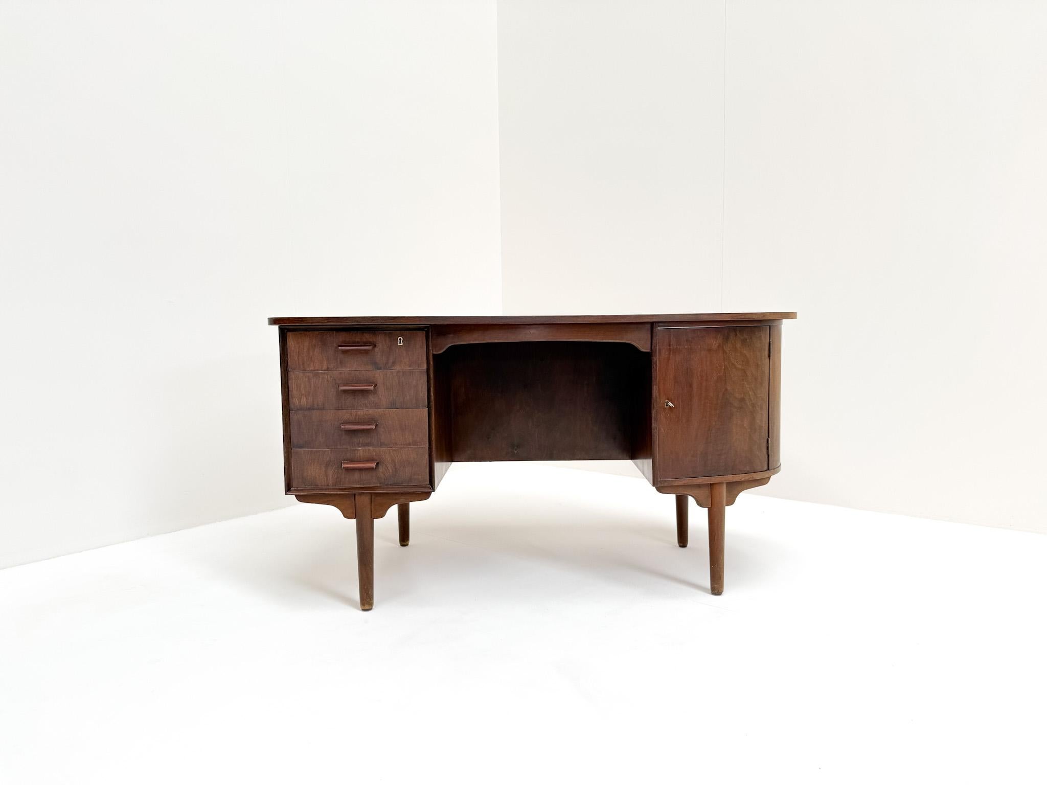 This exceptional mid-century walnut desk is a true statement piece, combining sculptural design with everyday functionality. Its curved organic top showcases the natural walnut grain and gives the desk a soft, elegant silhouette that distinguishes