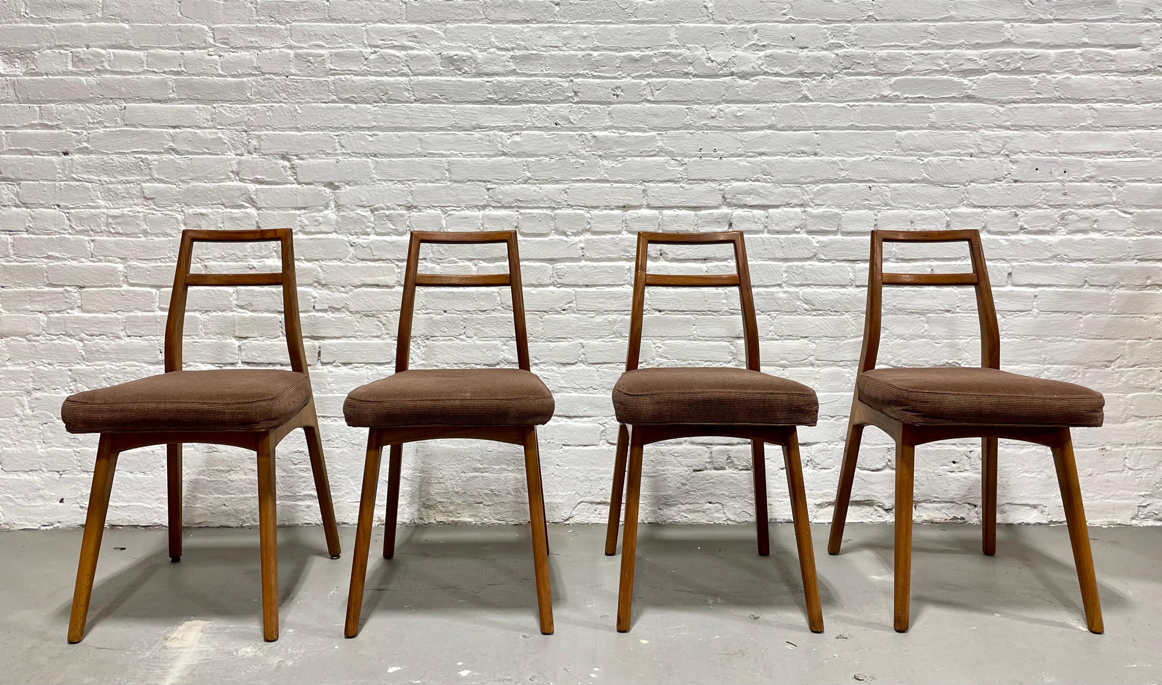 Mid-Century Modern dining chairs by Mel Smilow, set of four. Frames feature lovely sculptural backrests and floating seats. Floating seat design adds an air of lightness and elegance to the frame. The chairs have been cleaned and oiled and the brown