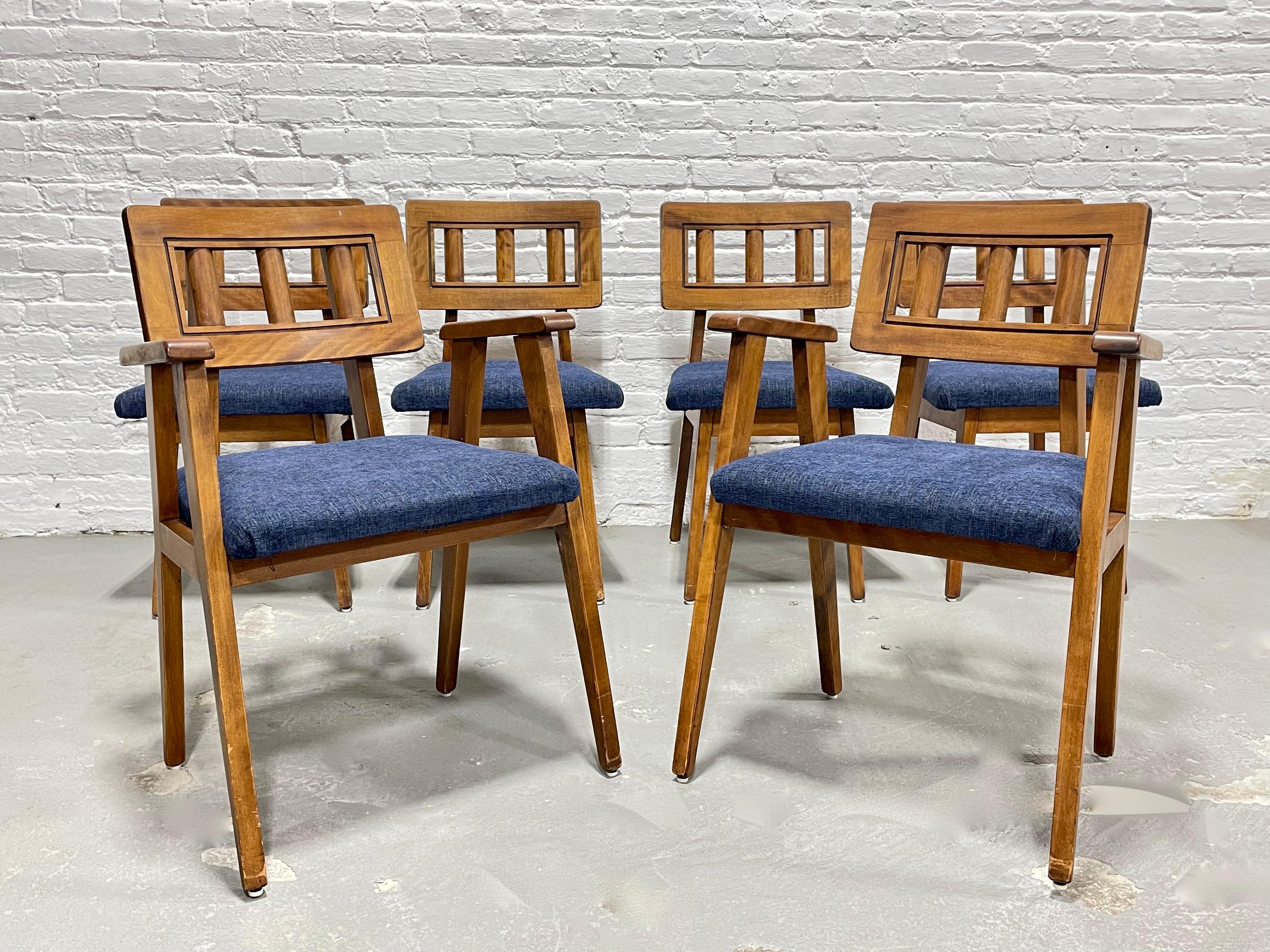 Set of six rare Mid-Century Modern walnut dining chairs featuring new denim upholstery. The square spindled back supports are so sweet and the denim colored upholstery contrasts beautifully with the walnut frames. Seats are plush and comfy and the