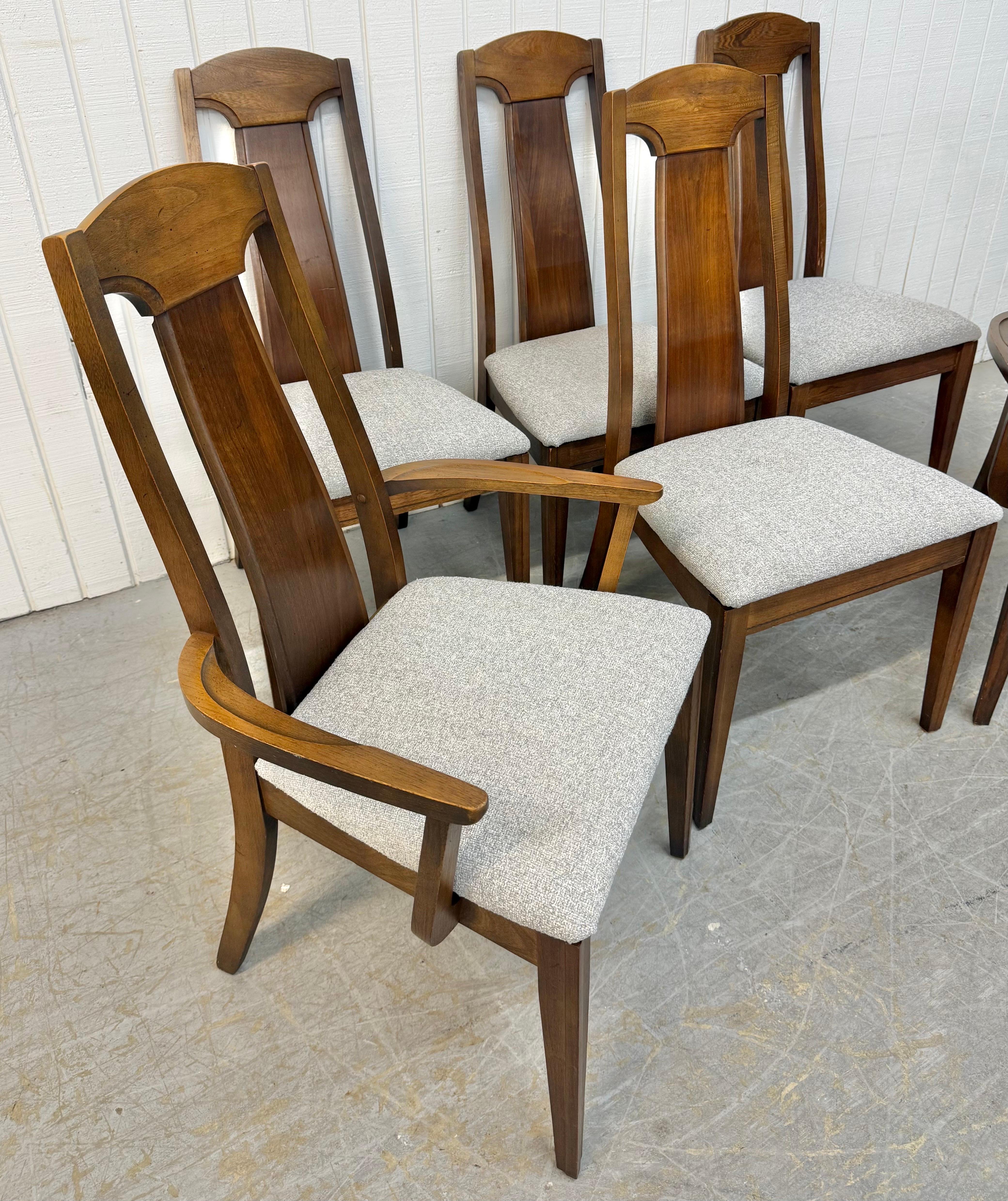 This listing is for a set of six Mid-Century Modern Walnut Dining Chairs. Featuring a straight line high back design, solid wood frames, newly upholstered gray seats, and a beautiful walnut frame. This is an exceptional combination of quality and