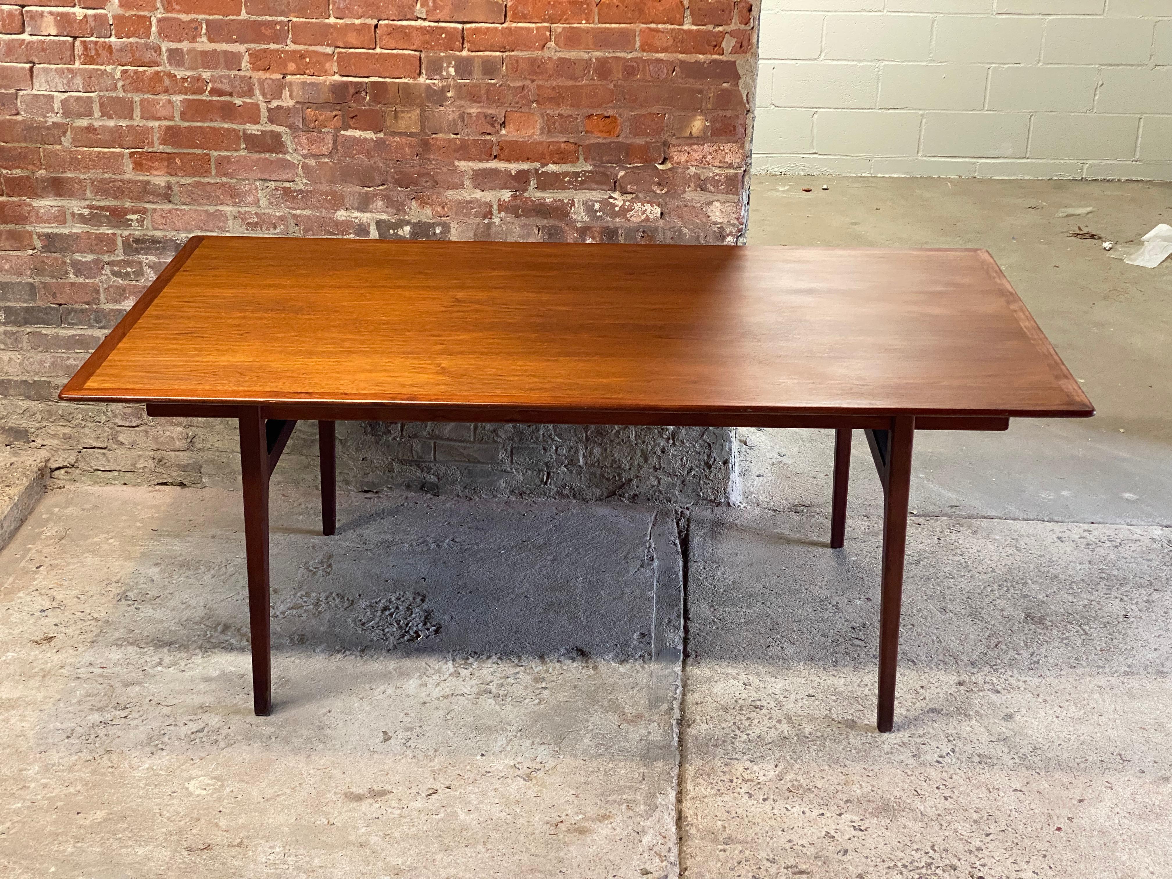 Large, distinct and rare Mid Century Modern Walnut dining table with two leaves designed by Al Huller Furniture Company, Inc. New York, New York for Furnwood Corporation, Brockton, MA. Circa 1965. Signed with metal tag un the underside of the table.