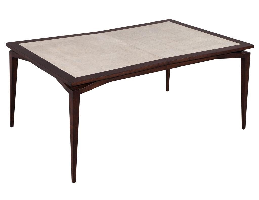 Mid-Century Modern walnut dining table by Tomlinson Furniture. America circa 1970’s, composed of walnut and Carpathian elm. Masterfully restored in a modernized 2-tone satin finish. Table has unique bowtie design with tapered legs. Includes 2