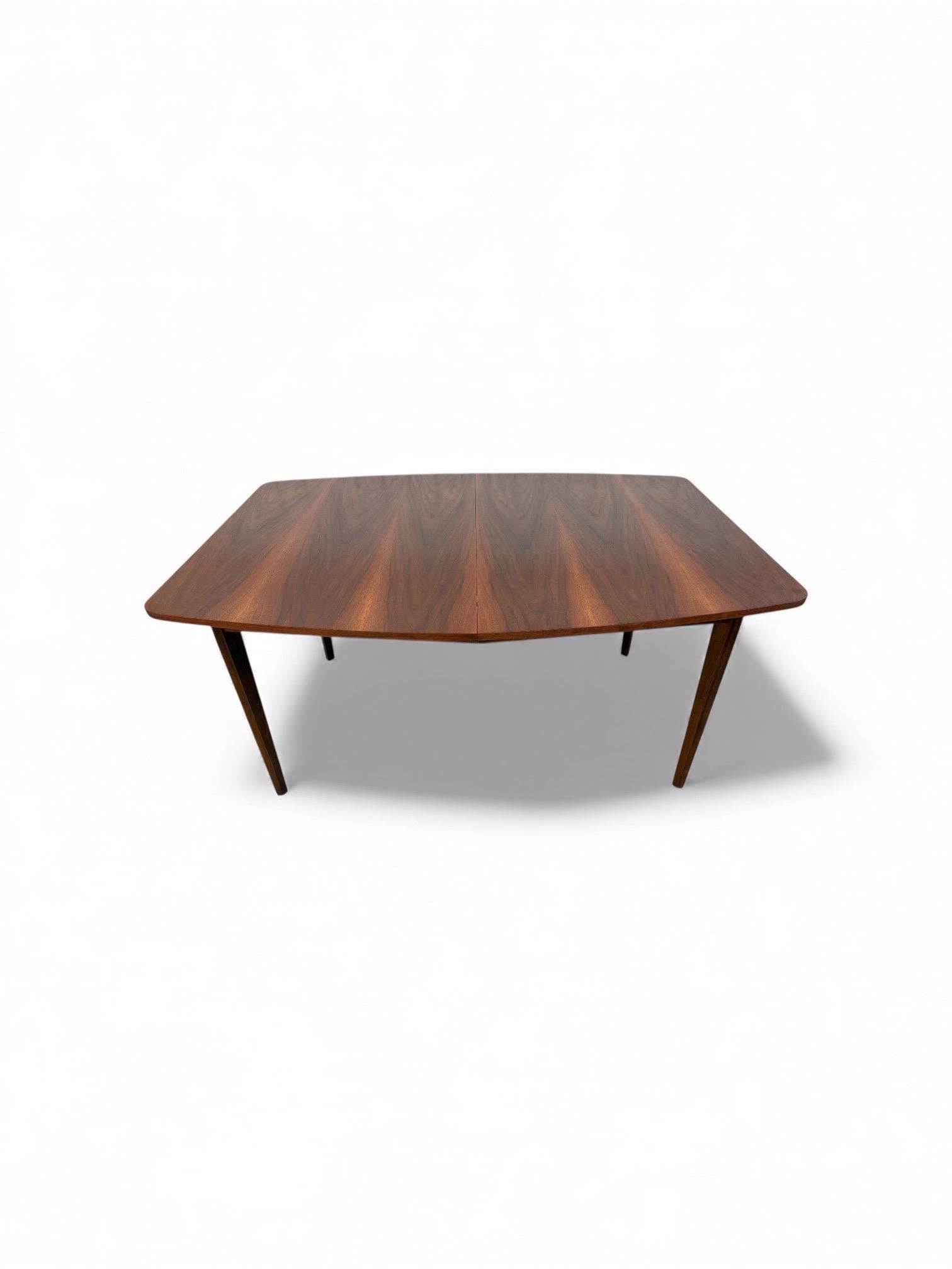 This listing is for a Mid-Century Modern Walnut Dining Table. Featuring a straight line design, rectangular walnut top, four removable modern legs, and a beautiful walnut finish. This is an exceptional combination of quality and MCM design!