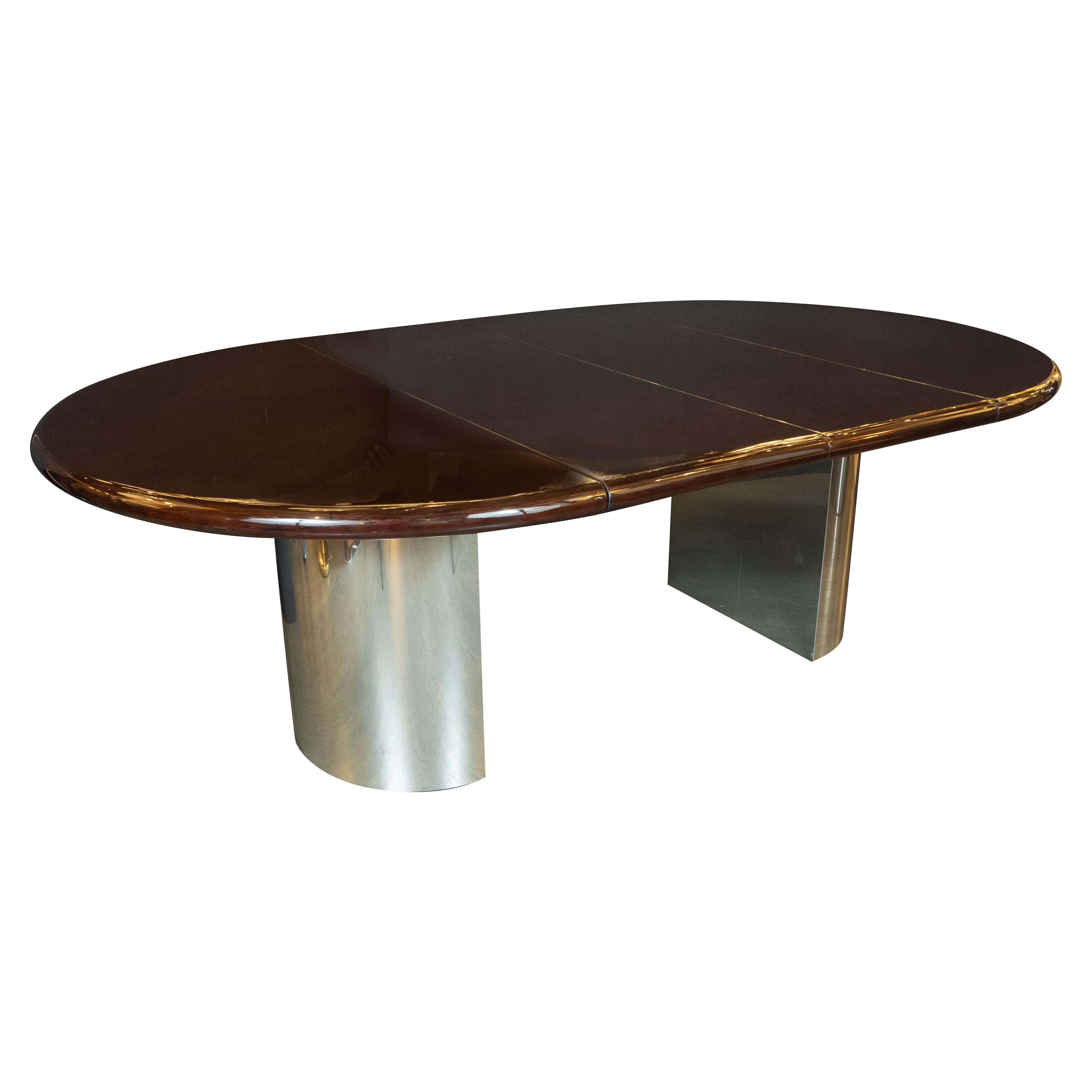 This magnificent Mid-Century Modern dining table was realized by the esteemed American maker, Directional in the United States, circa 1970. It features two demilune form curved feet in polished chrome that support a circular walnut tabletop. The