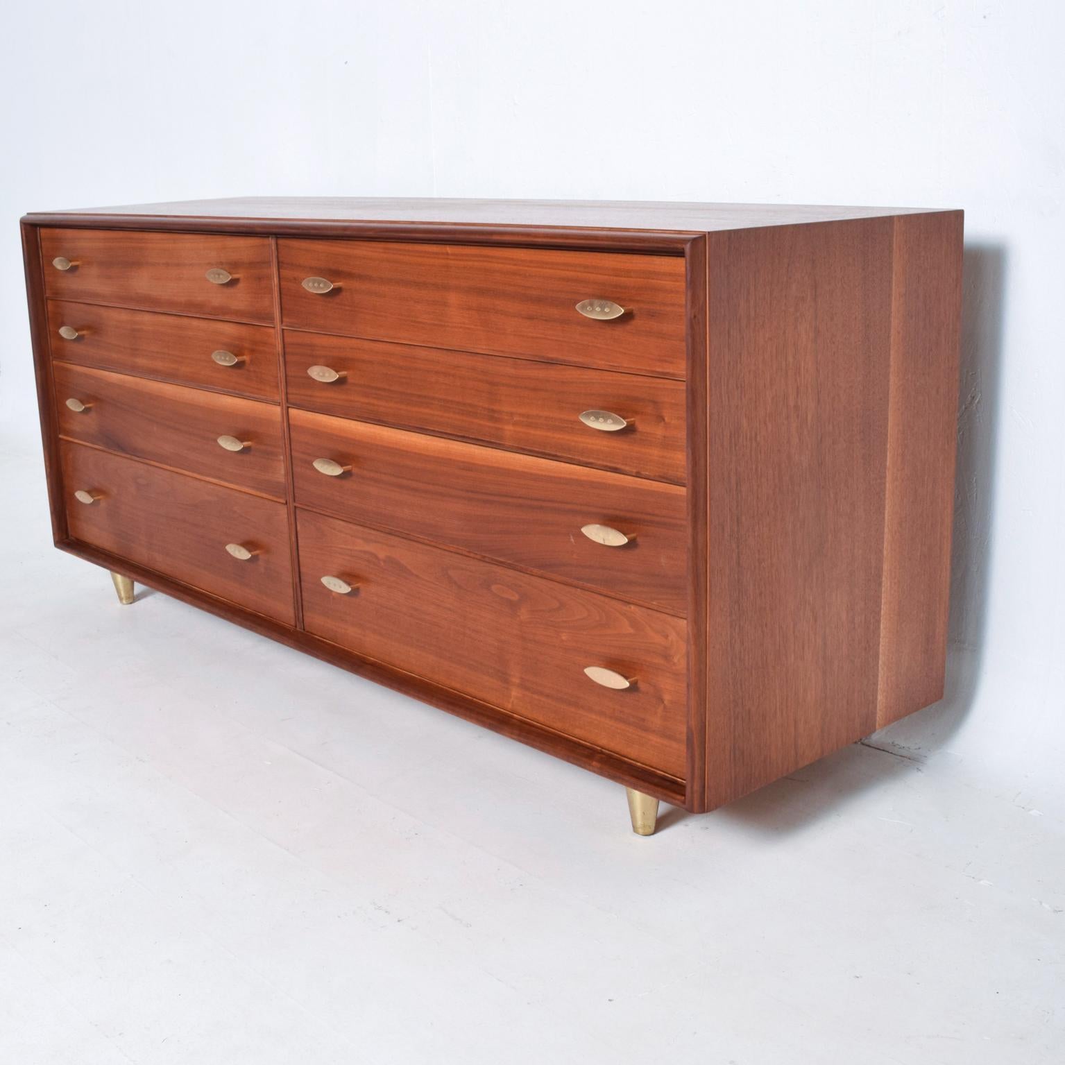 For your consideration, a Mid-Century Modern walnut double dresser by Paul Frankl for John Stuart. Beautiful double dresser in walnut wood with original brass plated pulls. All the drawers open and close with ease and are constructed with double