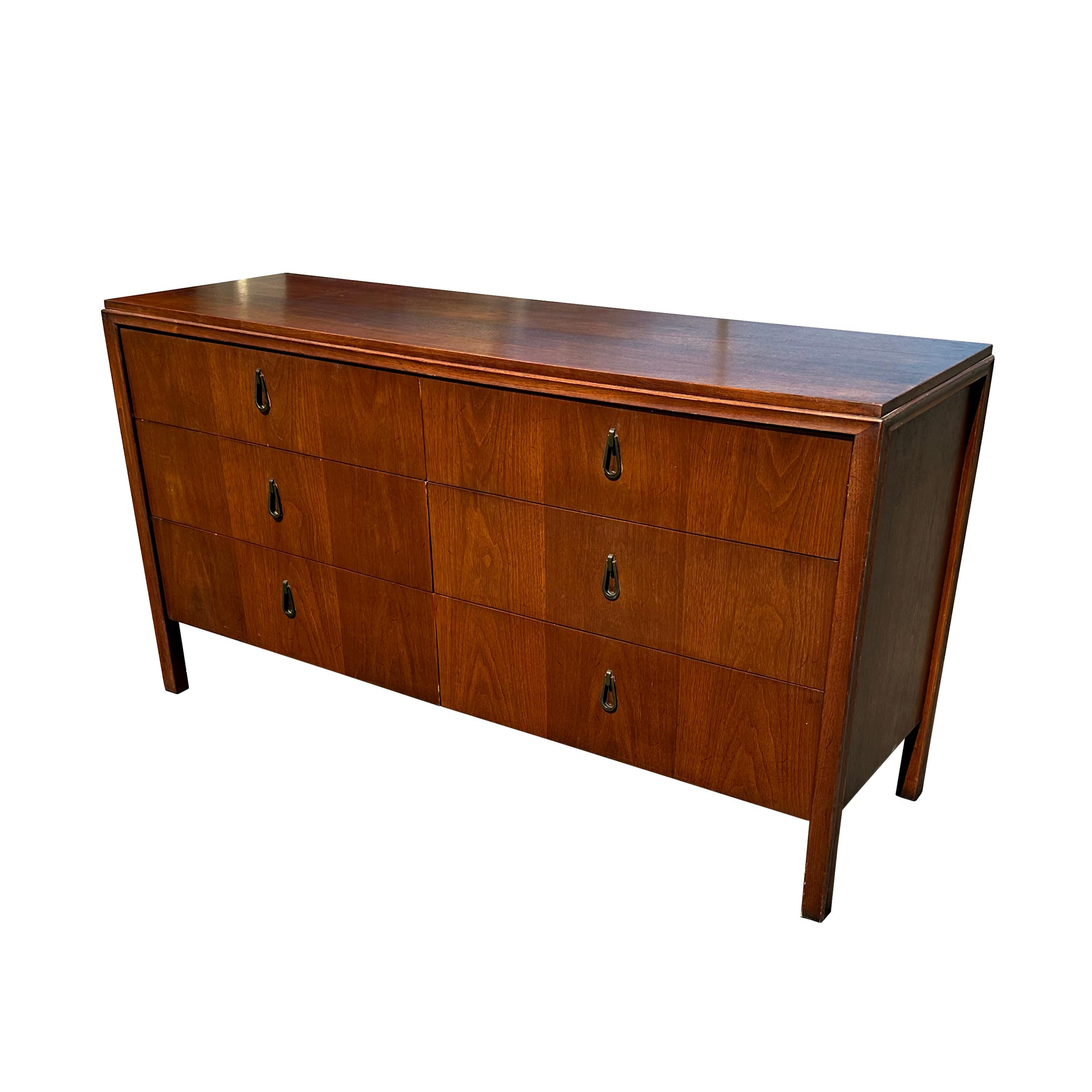 Sleek mid century modern design 6 drawer dresser with original tear drop hardware. Great quality walnut double dresser by Mount Airy Furniture Company. This design is classic and would look great many different styles of decor. Use this piece in a