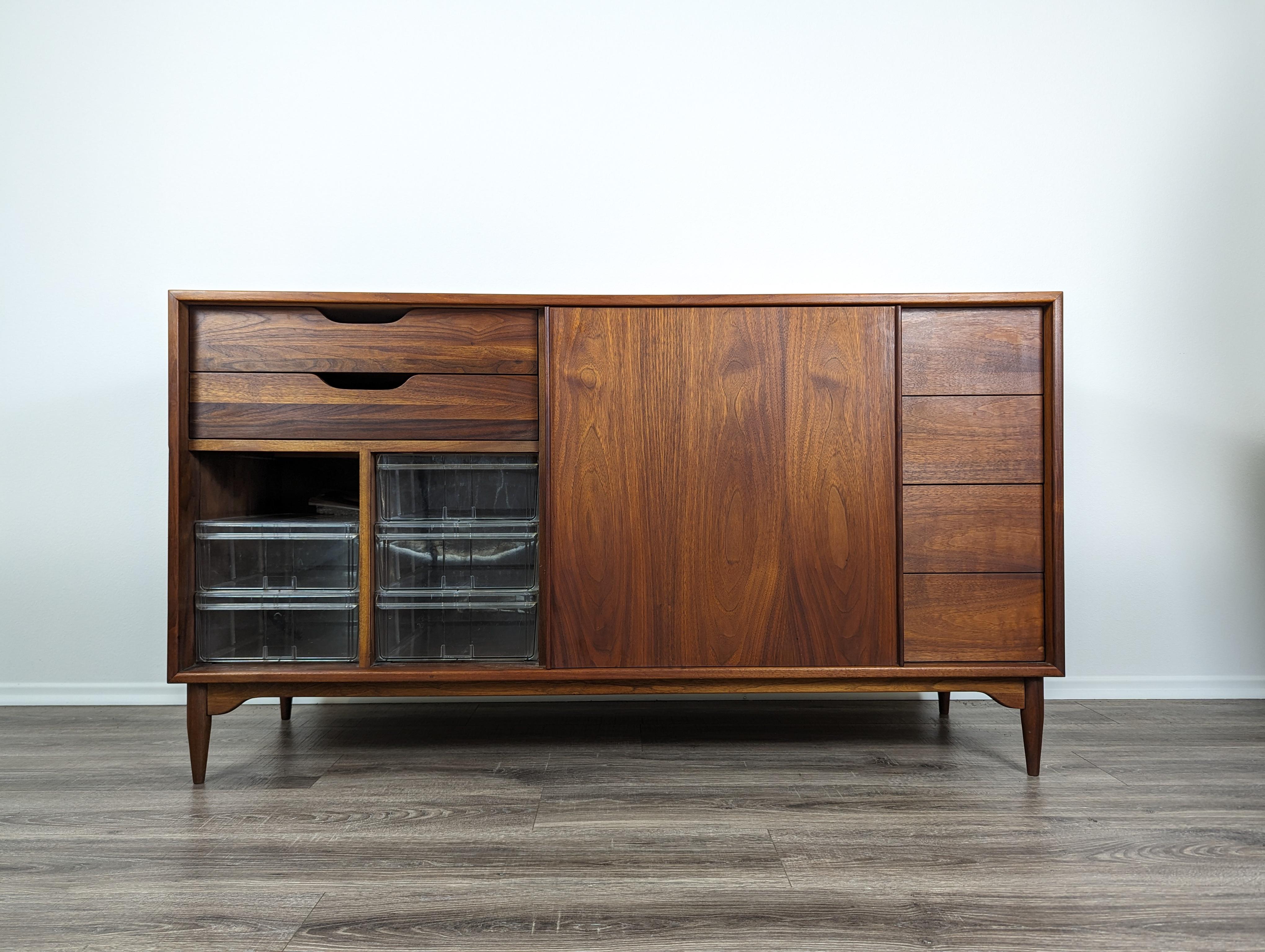 Step back in time with this stunning Mid Century Modern Walnut Dresser by renowned Brown Saltman. Masterfully crafted in the 1960s, this piece beautifully encapsulates the era's penchant for simplicity, functionality, and natural