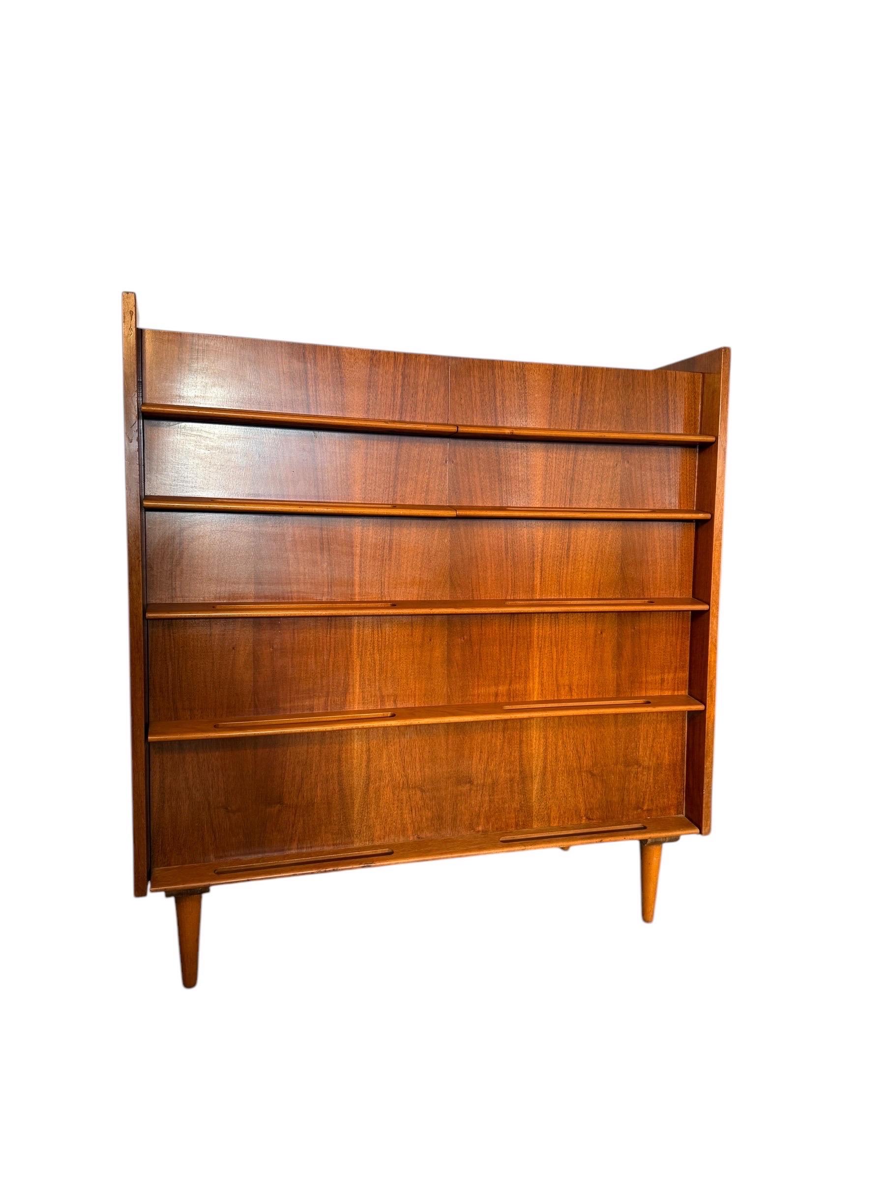 This mid-century modern dresser, designed by renowned designer Edmund Spence, combines bold functionality with timeless style. Known for his sophisticated craftsmanship and Scandinavian-inspired designs, Spence created pieces that emphasized clean