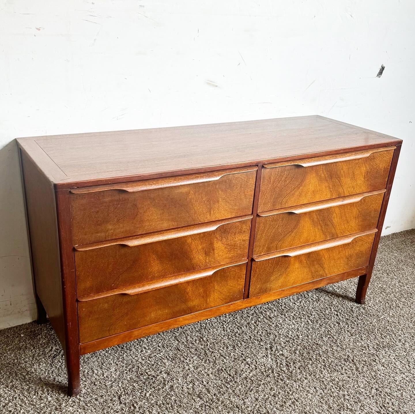 Embrace the timeless style of mid-century design with this Mid Century Modern Walnut Dresser by Sligh. Featuring six spacious drawers with dividers for easy organization, this dresser is crafted from rich walnut wood, offering both elegance and
