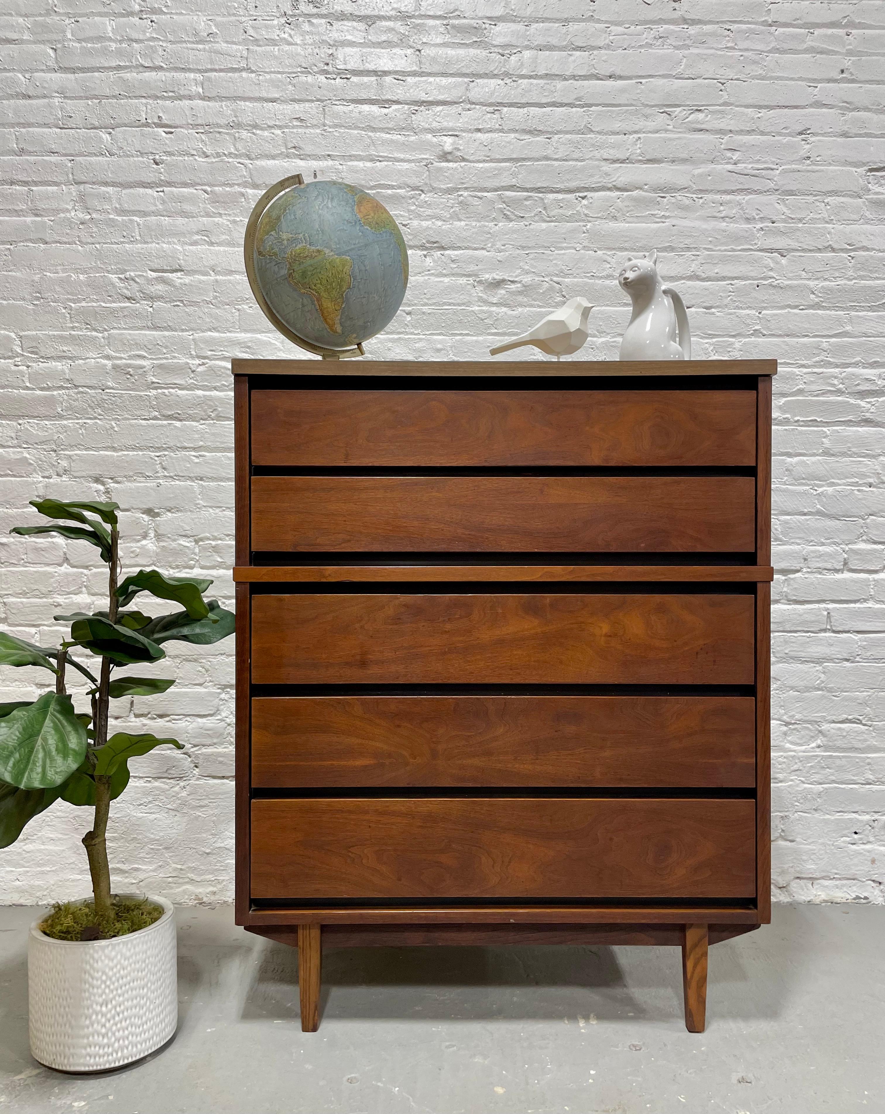 Mid Century Modern Walnut Dresser by Stanley Furniture Co., c. 1960's. This solid dresser offers a ton of storage space over five spacious drawers.  Gorgeous woodgrains and the wood is a rich, deep walnut color. Laminate tabletop, perfect for
