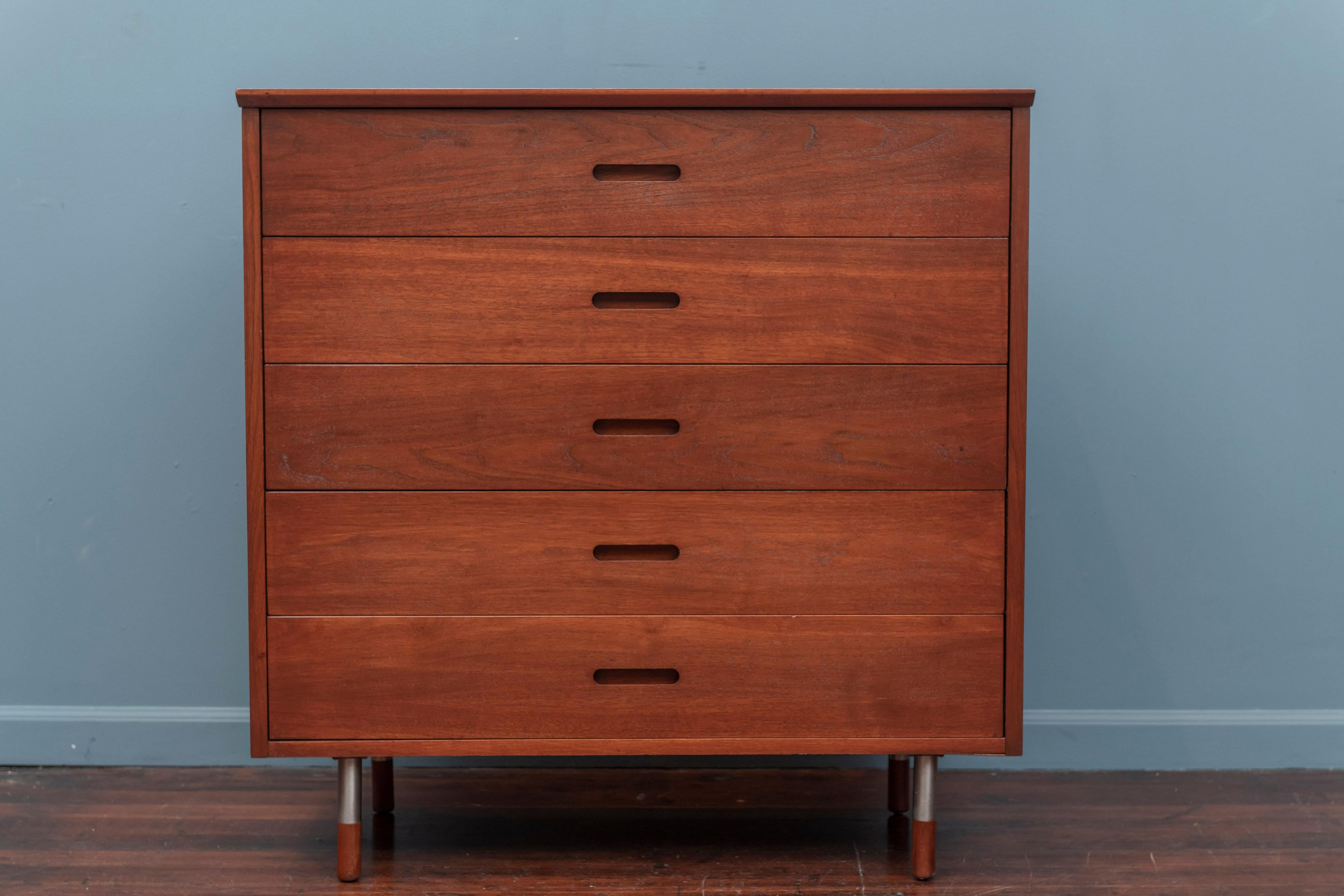 Mid-Century Modern walnut five drawer dresser with steel legs capped by walnut turned feet. 
Newly refinished and ready to install.