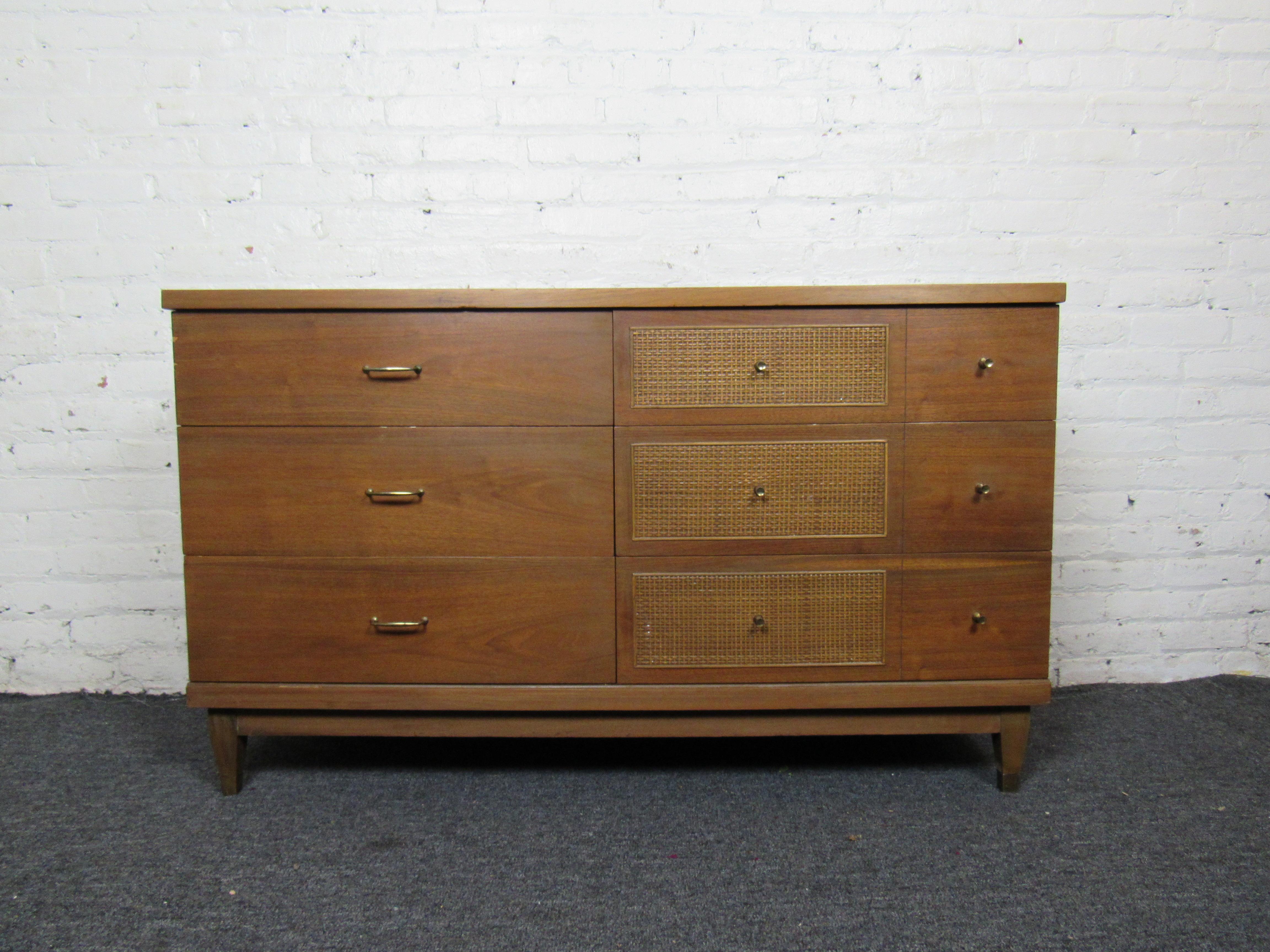 Very nice mid-century dresser with brass fixtures and wicker accents. Six pull-out drawers in a variety of sizes for ample storage and organization. Please confirm item location with seller (NY/NJ).