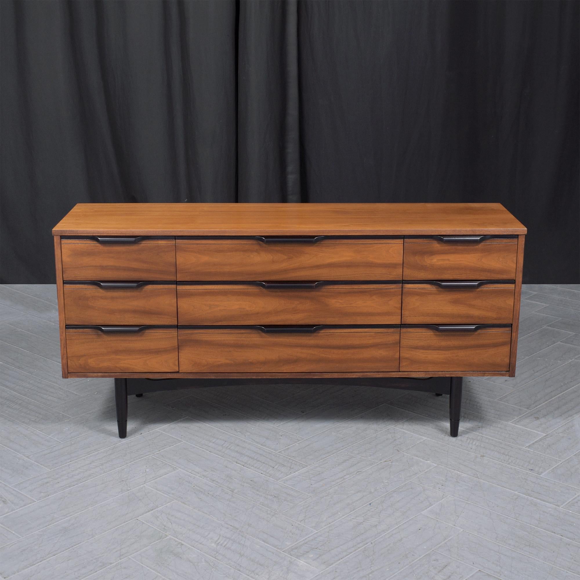 Elevate your living or dining room decor with this striking 1960s Mid-Century Modern walnut credenza. Meticulously hand-crafted from walnut wood, this vintage dresser stands out in its great condition, having been expertly restored by our dedicated