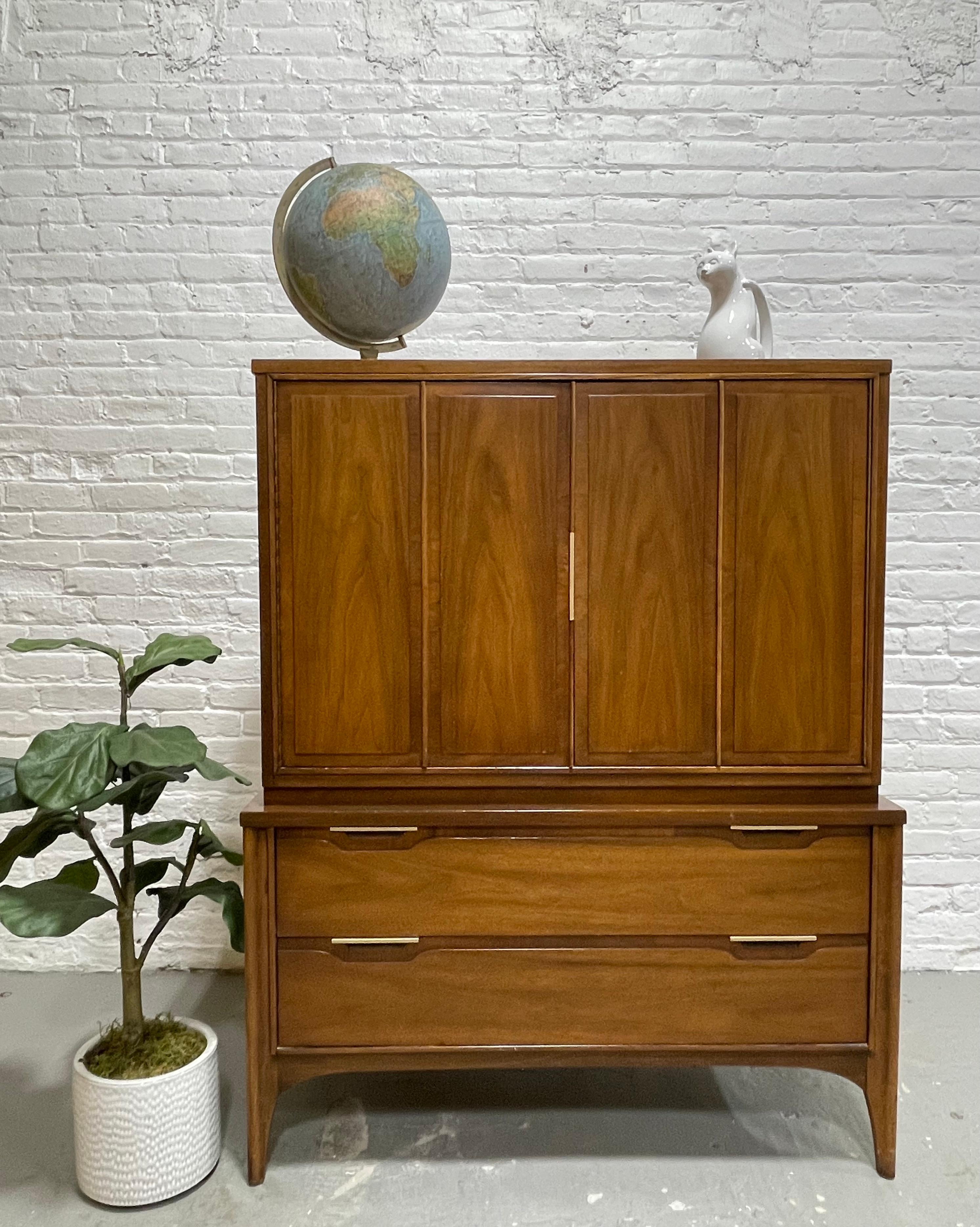 Mid-Century Modern Walnut Dresser / Highboy by Kent Coffey's Impact line, circa 1960s. Gorgeous wood grains with metal trim along the handpulls, top doors that open on piano hinges to reveal a wealth of storage. If you need one piece to hold