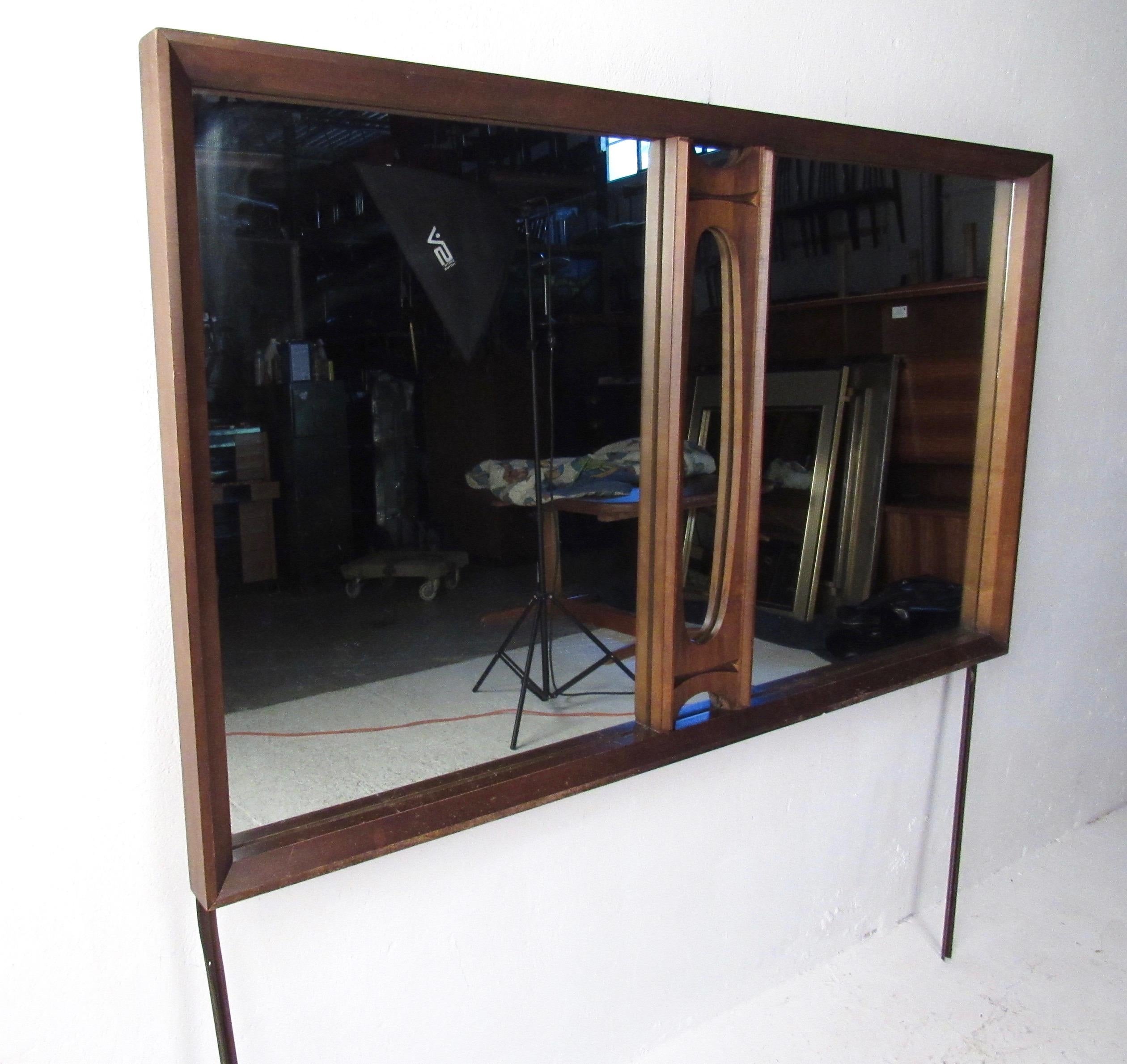 This stylish Mid-Century Modern mirror boasts sculpted walnut trim and makes an impressive mirror for use on top of a bedroom dresser or updated to use as a hanging wall mirror. Please confirm item location (NY or NJ).