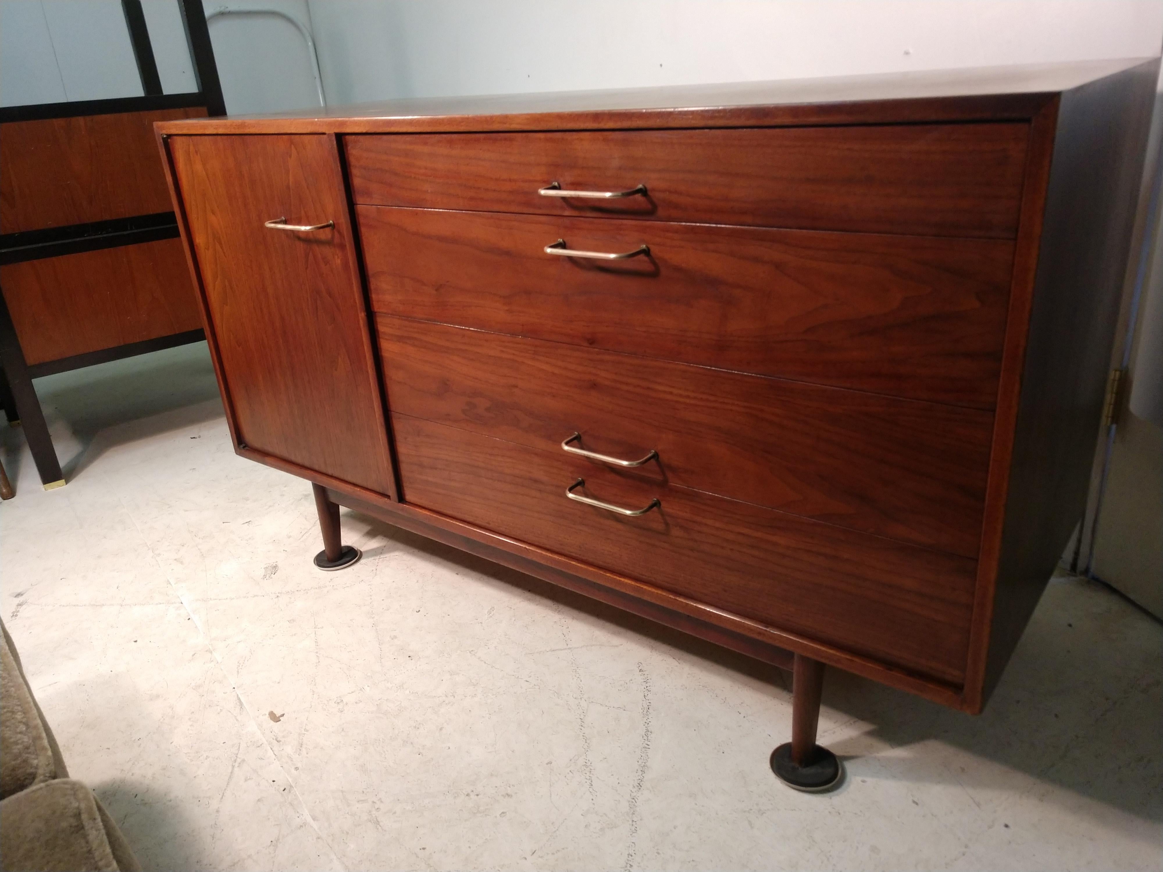 Fabulous walnut server or dresser. 5 drawers with a single door closer.
Signed on back Jens Risom design. Has been refinished with teak oil and wax for protection. A few minor ring stains on top. Maple interior gives a striking contrast. Copper