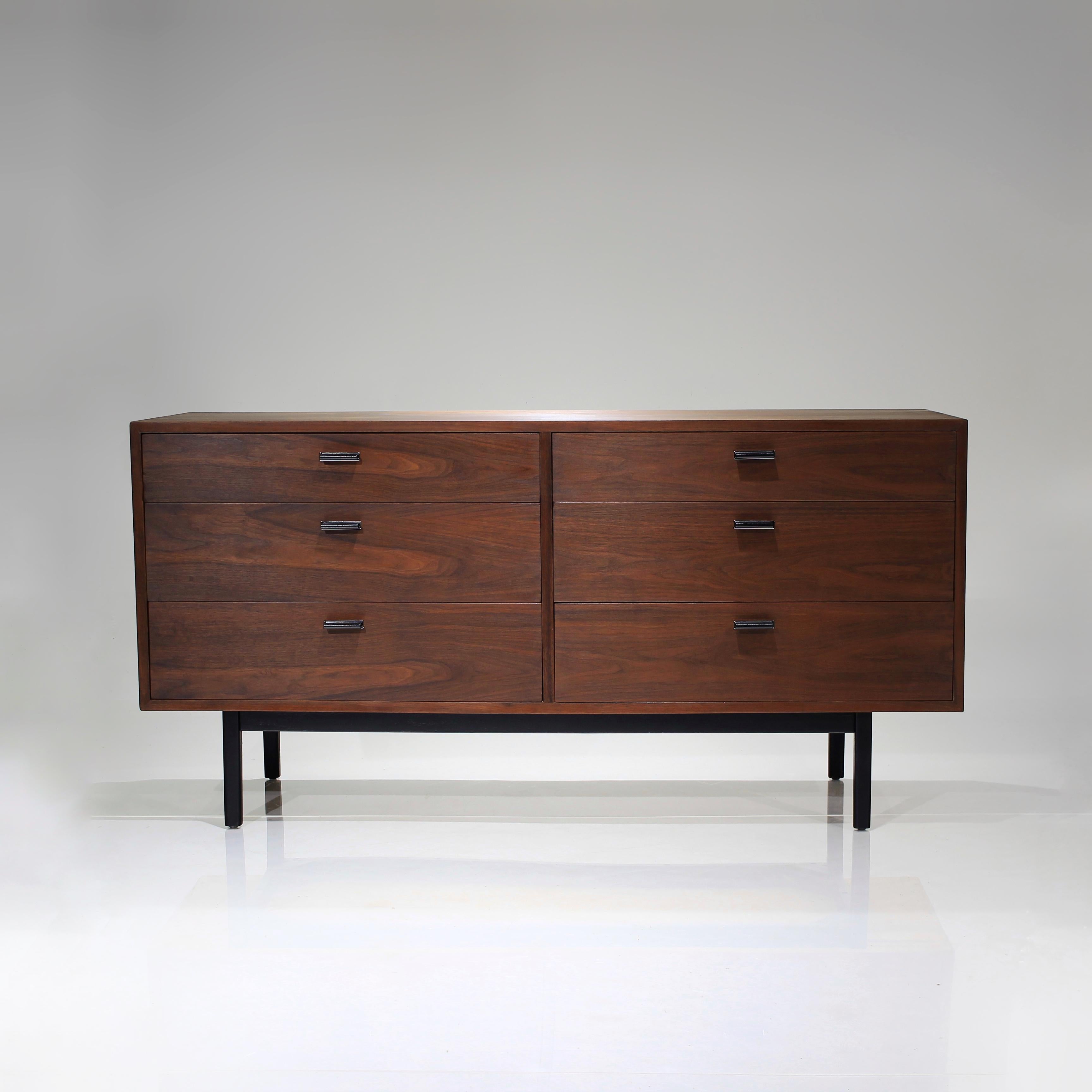 Presenting this gorgeous 6 drawer Walnut Dresser by Jack Cartwright for Founders.

Absolutely clean lines, accentuated steel black pulls with chromed plate backing. Elevated by the matching black base, tying it all together beautifully.

Ample