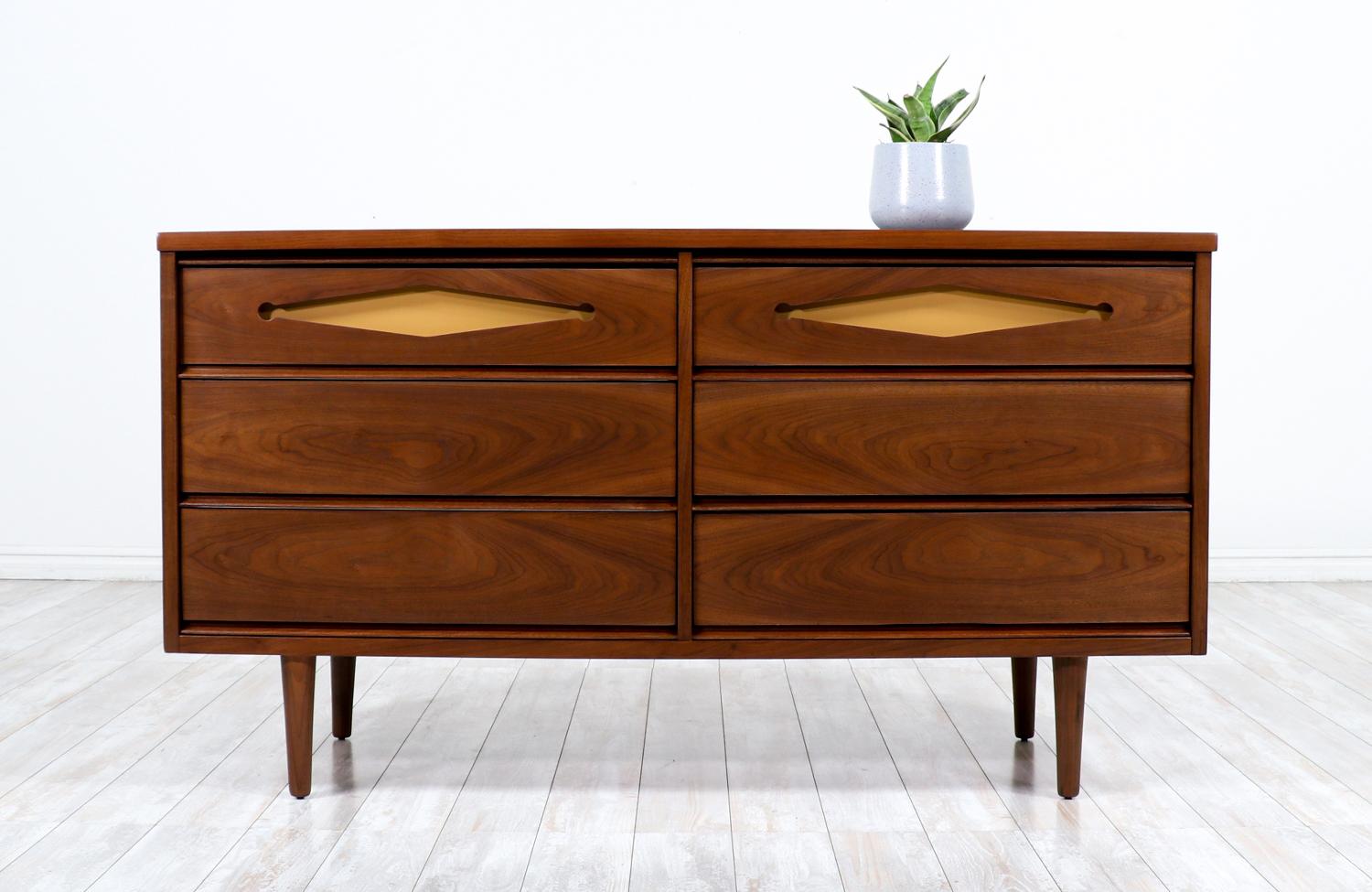 Mid-Century Modern walnut dresser with lacquered accent drawers.

________________________________________

Transforming a piece of Mid-Century Modern furniture is like bringing history back to life, and we take this journey with passion and