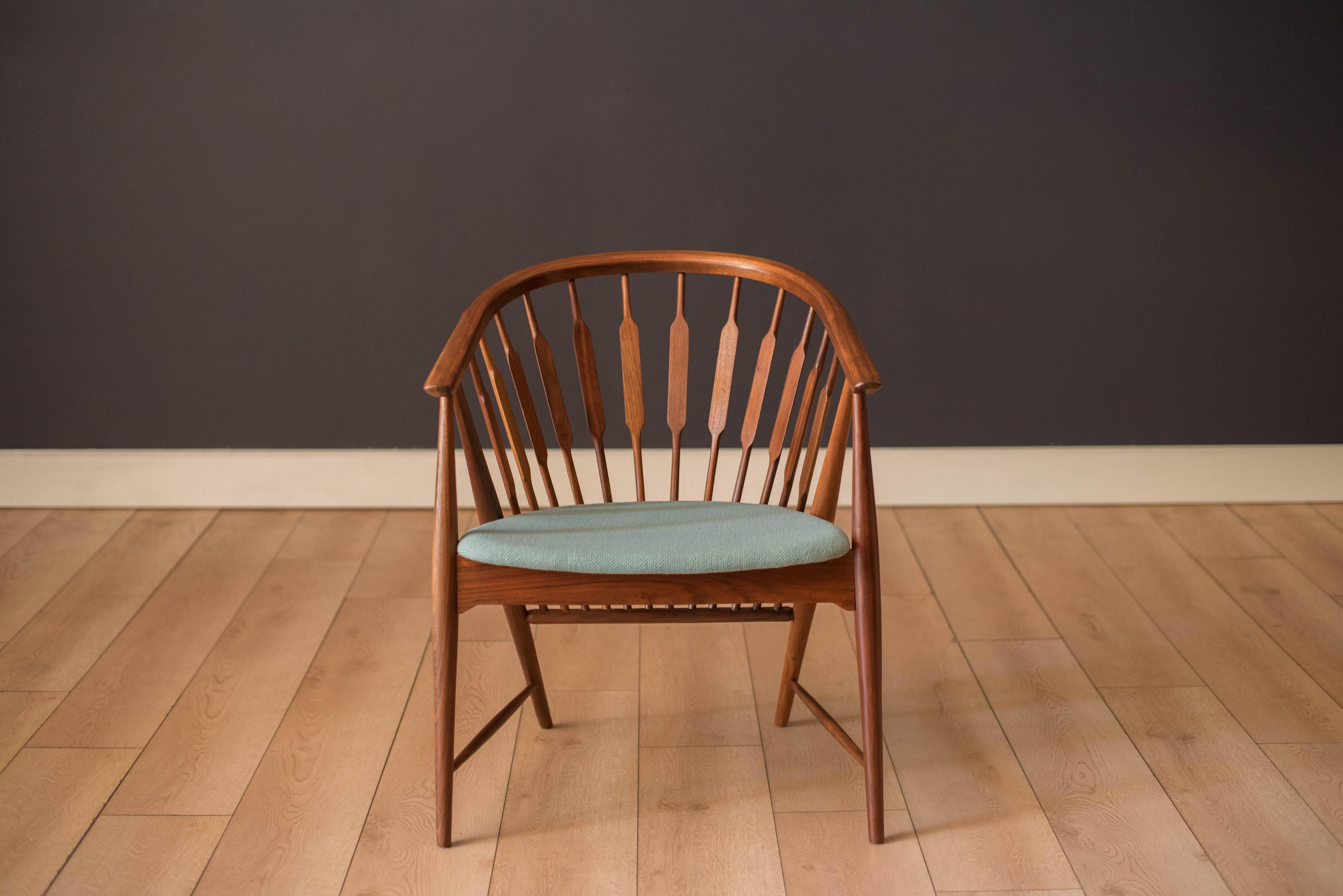 Mid-Century Modern armchair designed by Kipp Stewart and Stewart McDougall for Drexel Declaration. This piece is made of sculpted solid walnut and showcases from all angles. Functions as a captain's dining chair or lounge armchair. Newly