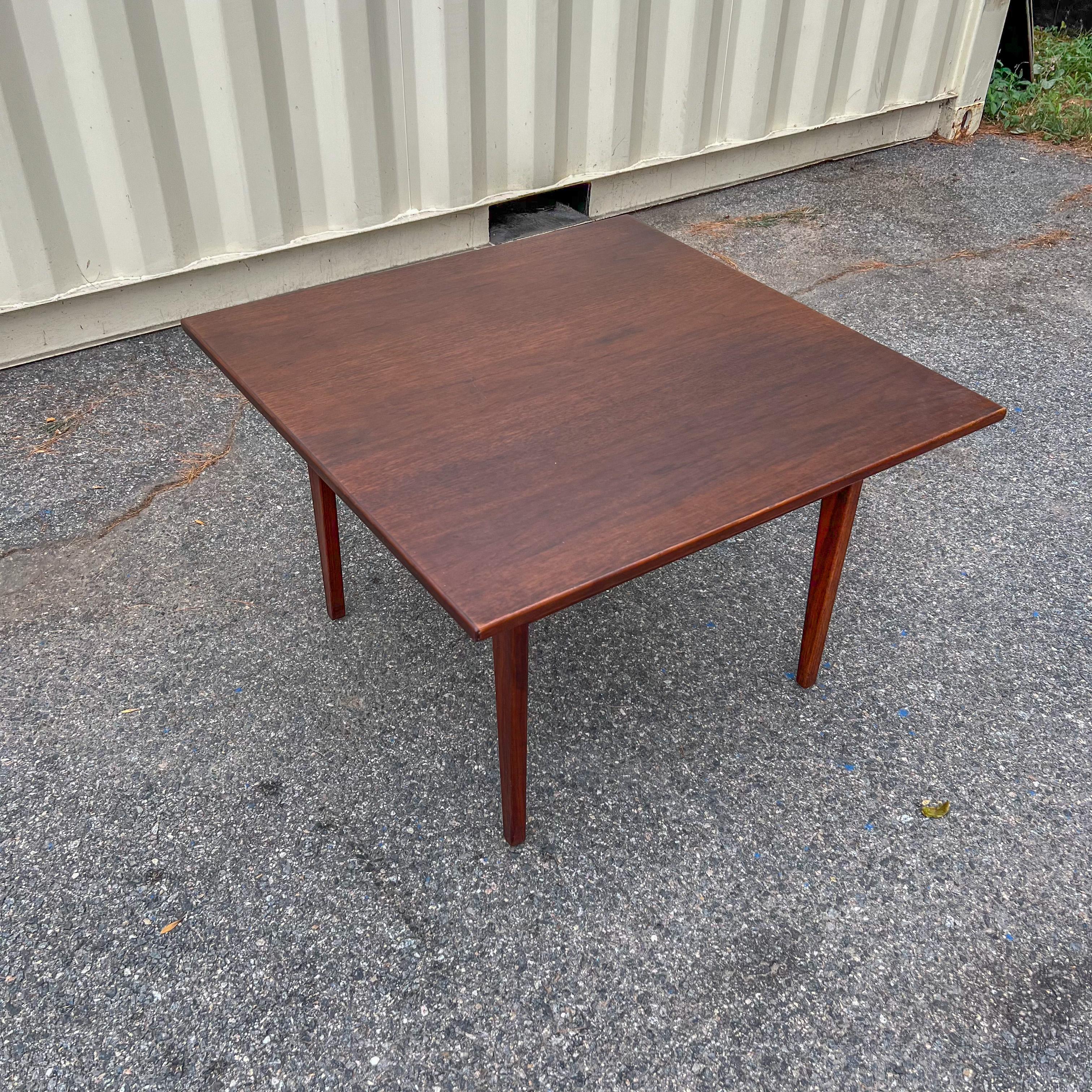 Mid-Century Modern walnut end table with sculpted legs designed by Jens Risom (stamped).