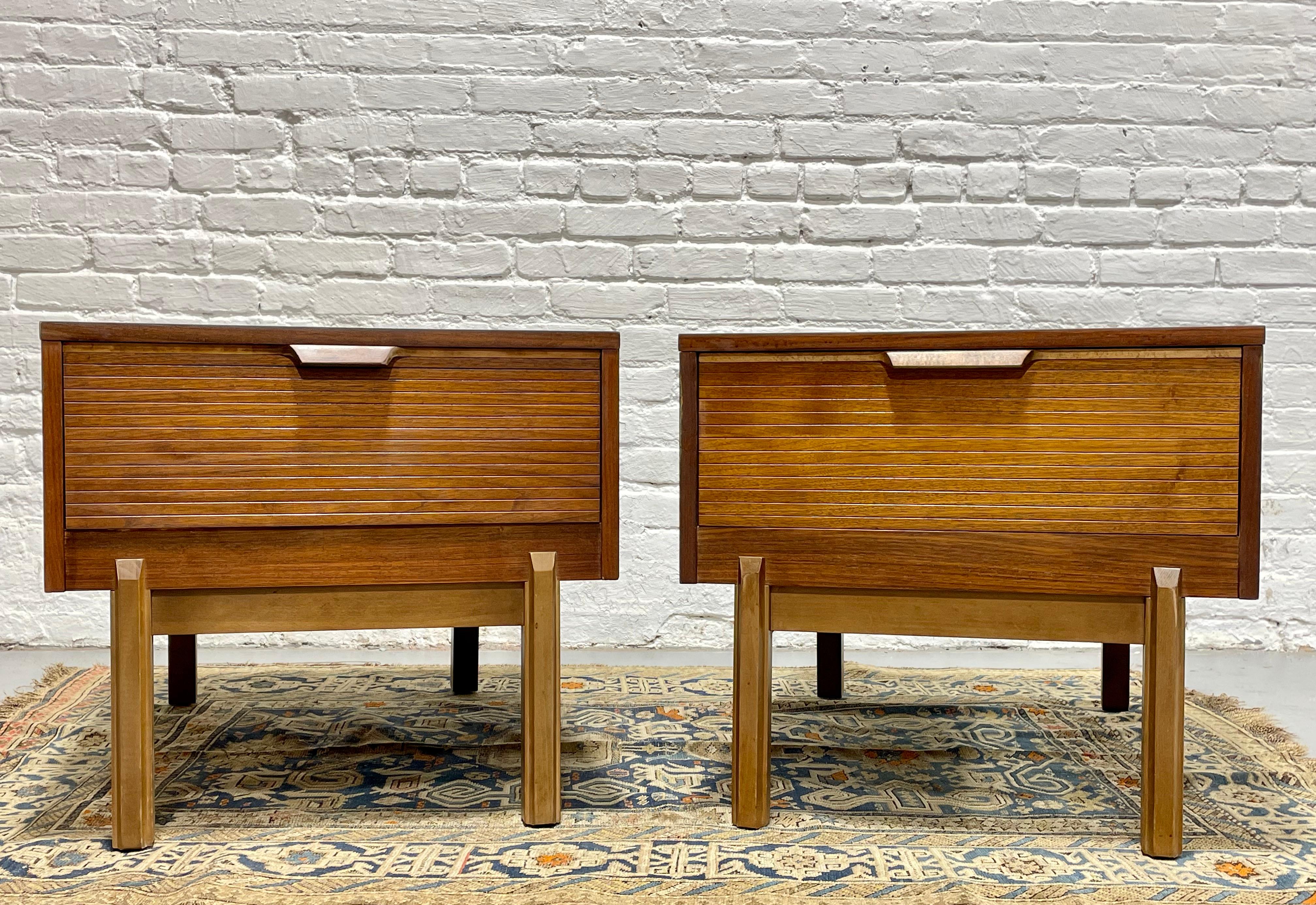 Pair of Mid Century Modern Walnut end / side tables with a deep + large drawer and striated drawer facade, c. 1960's.  The tables are perfect for either side of your sofa and there is plenty of space for table lamps, magazines/books or other