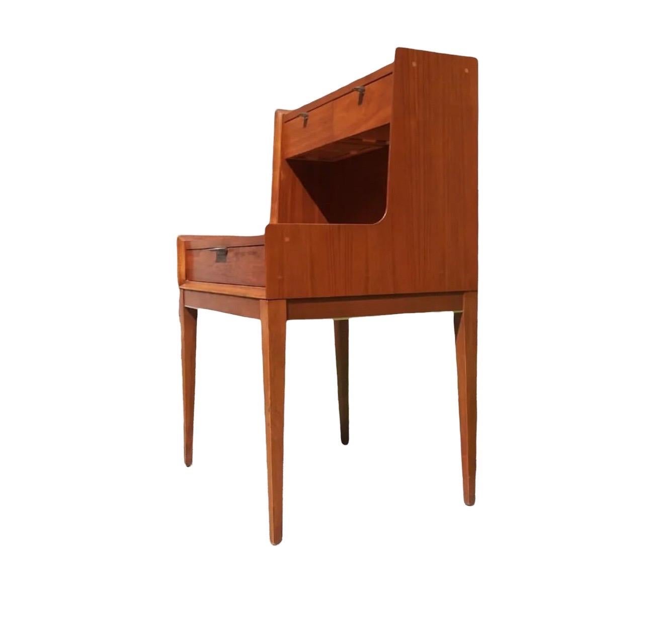 Vintage side table designed by Arthur Umanoff featuring tall legs and three drawers in a two-tier fashion. Whether its the aesthetic wood finish or elegant appearance these nightstands will make a great addition to any home or office space.
