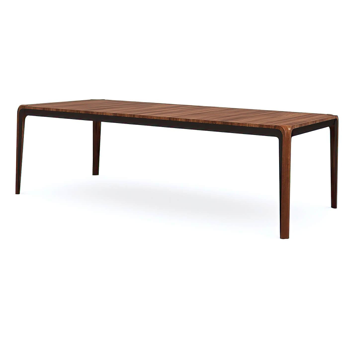 A Mid Century Modern-style walnut extending dining table with tapered legs. The tabletop is finished in rich walnut with mitered edges in Dark Chocolate. It features self-storing leaves and a foldable center support leg that tucks away neatly when