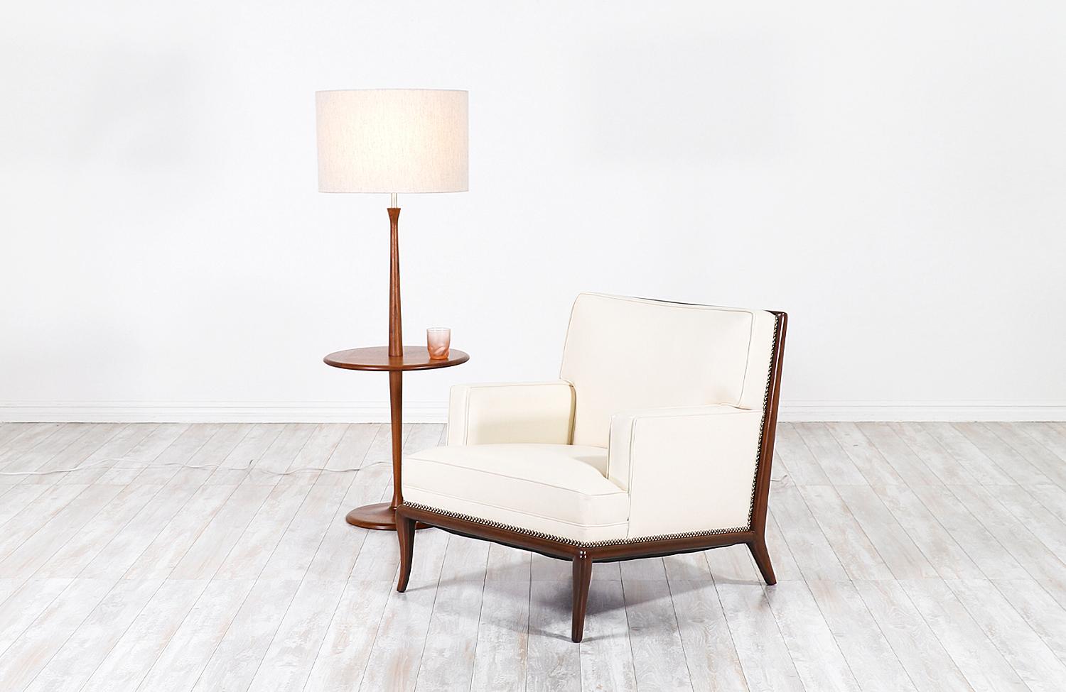 Modern floor lamp designed and manufactured by Laurel Lamp Co. in the United States, circa 1960s. This sleek, Minimalist design features a tall walnut wood body with a circular slate table surface and a weighted base that gives stability and style