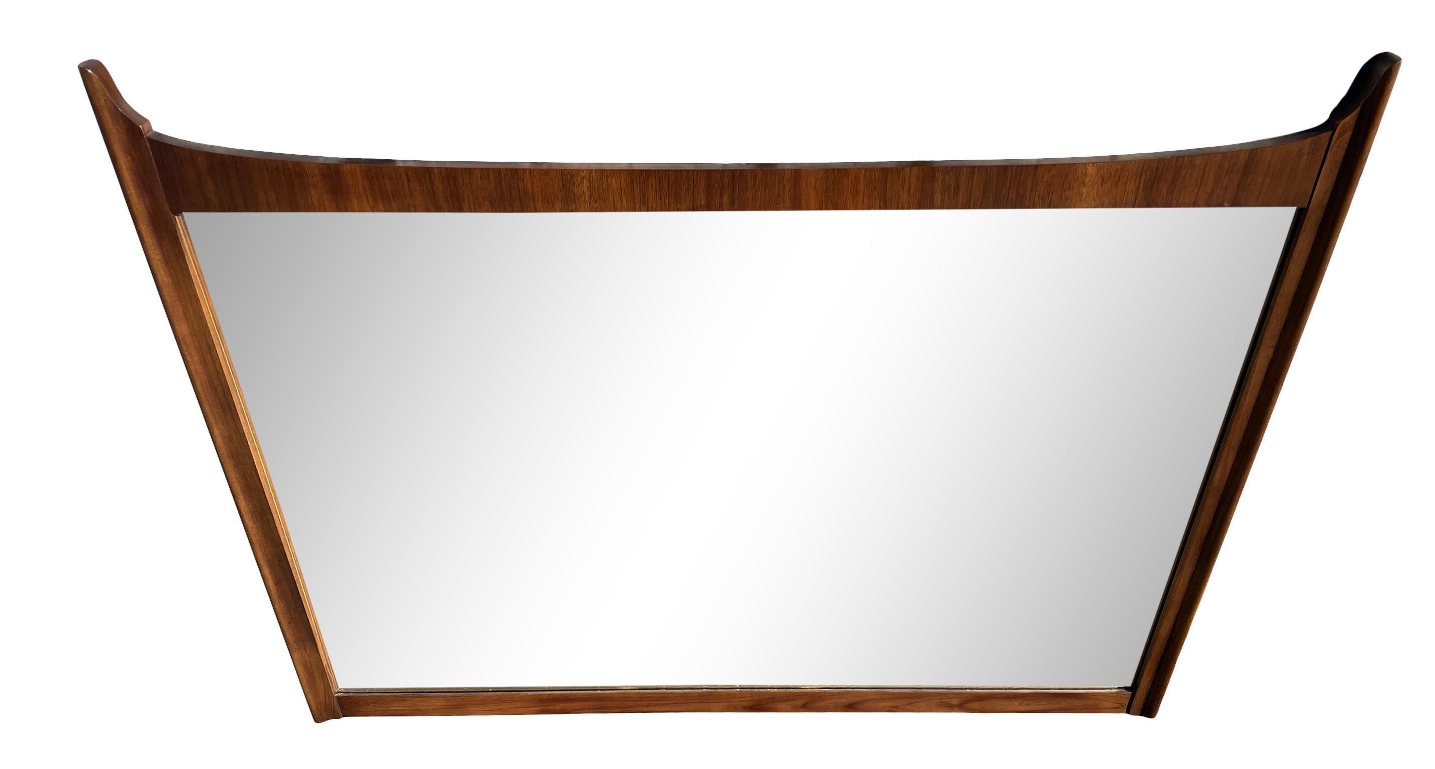 This wonderful Mid-Century Modern solid walnut mirror. No label. Will come with wire, wired to hang horizontal. Beautiful vintage condition and great high quality woodworking. Finished back. Solid and heavy. In style of Adrian Pearsall. Made in
