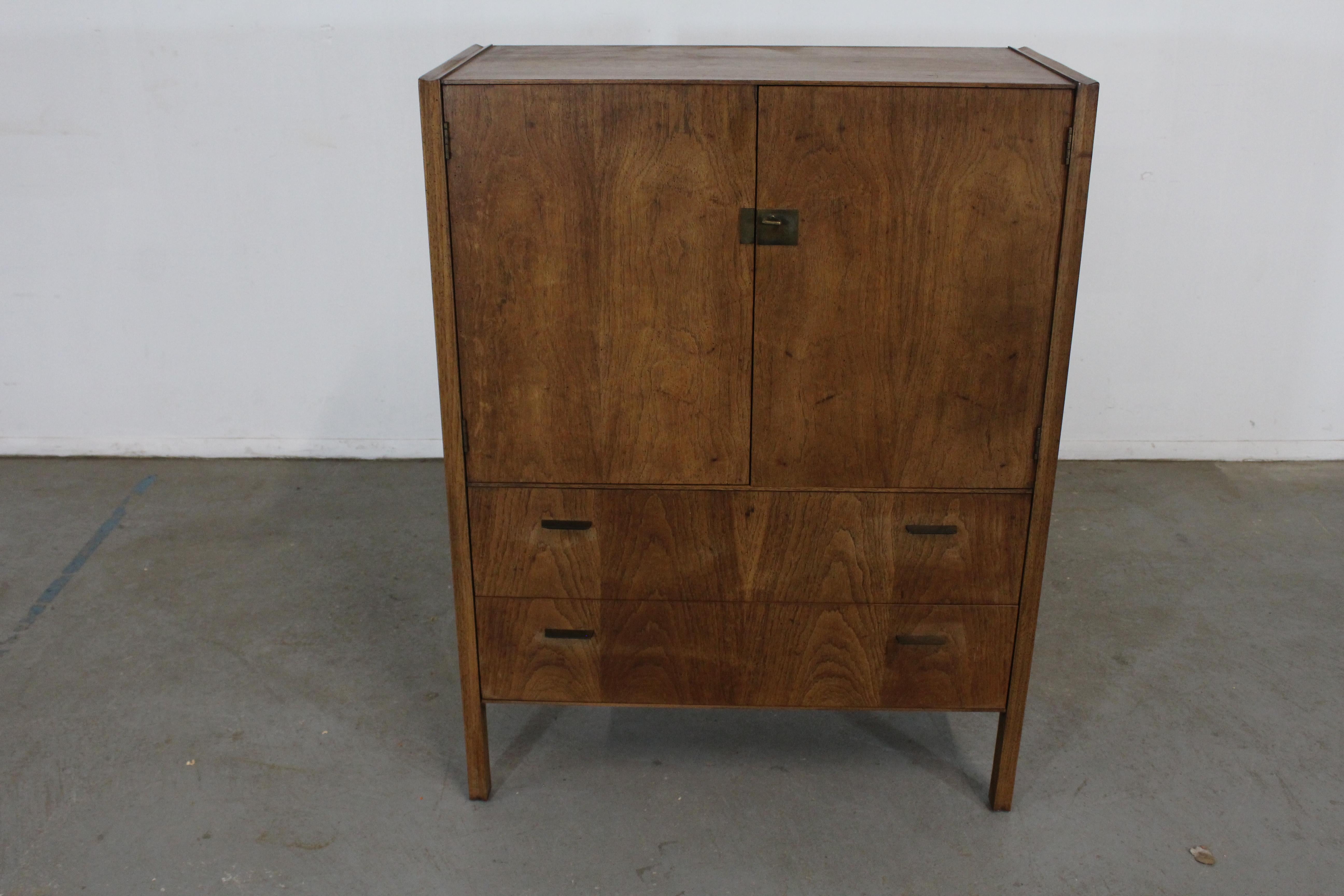 Mid-Century Modern Walnut Gentleman's Tall Chest

Offered is an excellent example of American mid-century modern design; a walnut dresser from the 1960's. Features dovetailed drawers with tapered legs and sculpted pulls. It is in excellent