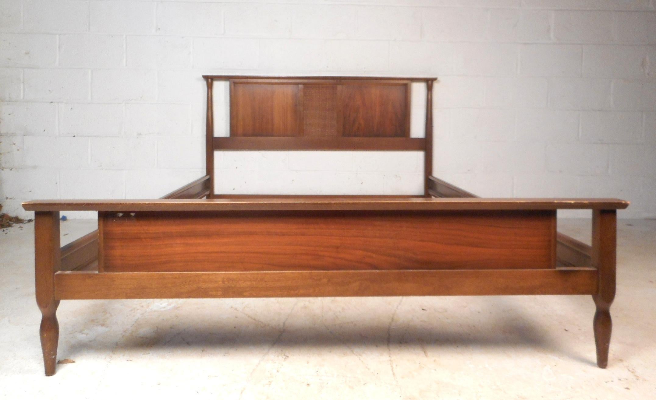 This beautiful vintage modern headboard and footboard comes with metal side rails. A sleek design with beveled edges, a woven style center, and tapered sides. This wonderful bed frame is well made and has an elegant vintage walnut finish throughout.