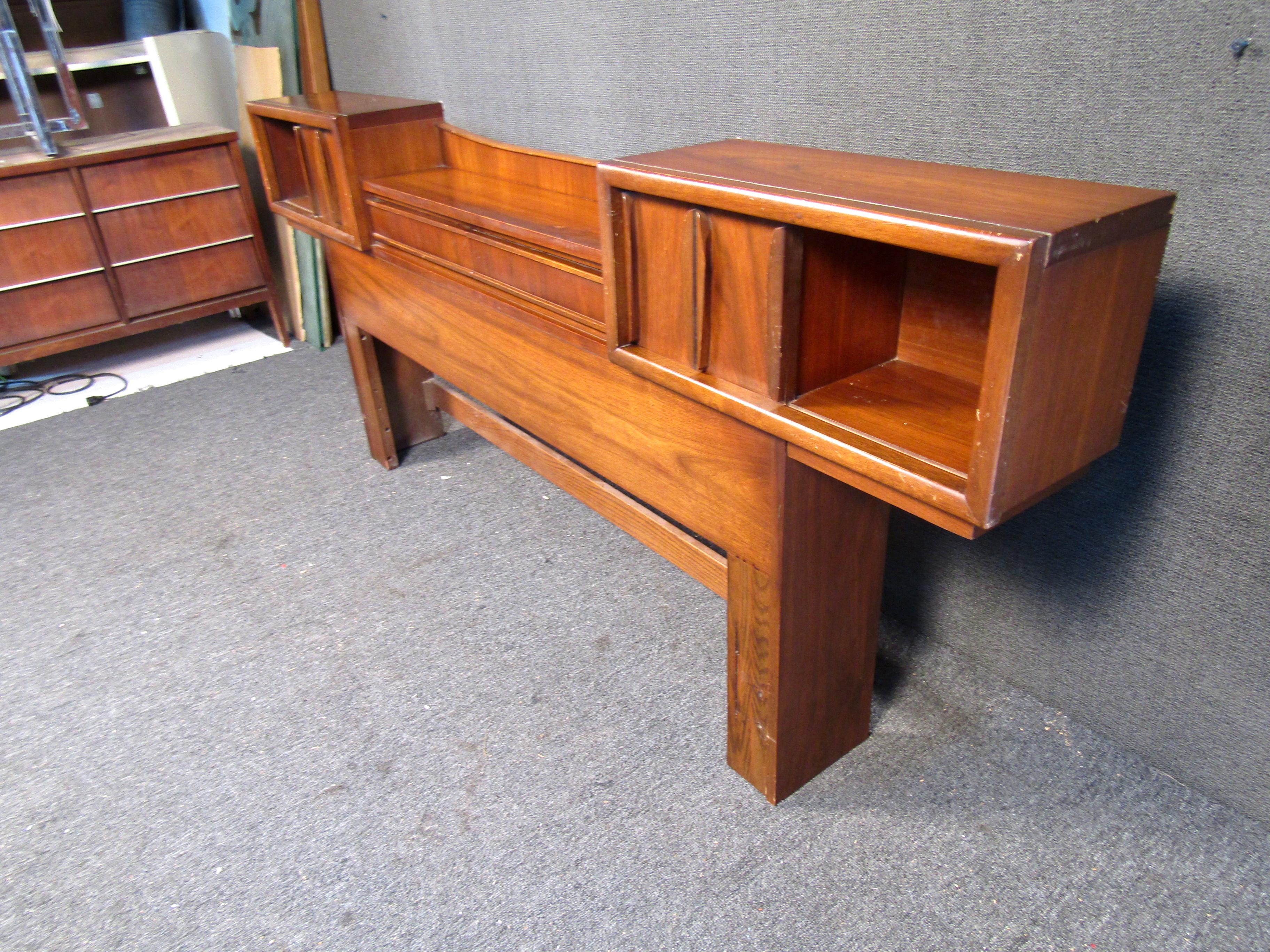 This headboard features rich walnut wood grain, two center drawers and two sliding door side cabinets. This vintage piece would be a perfect addition to any Mid Century bedroom.

*This headboard does not include rails or foot board*

Please
