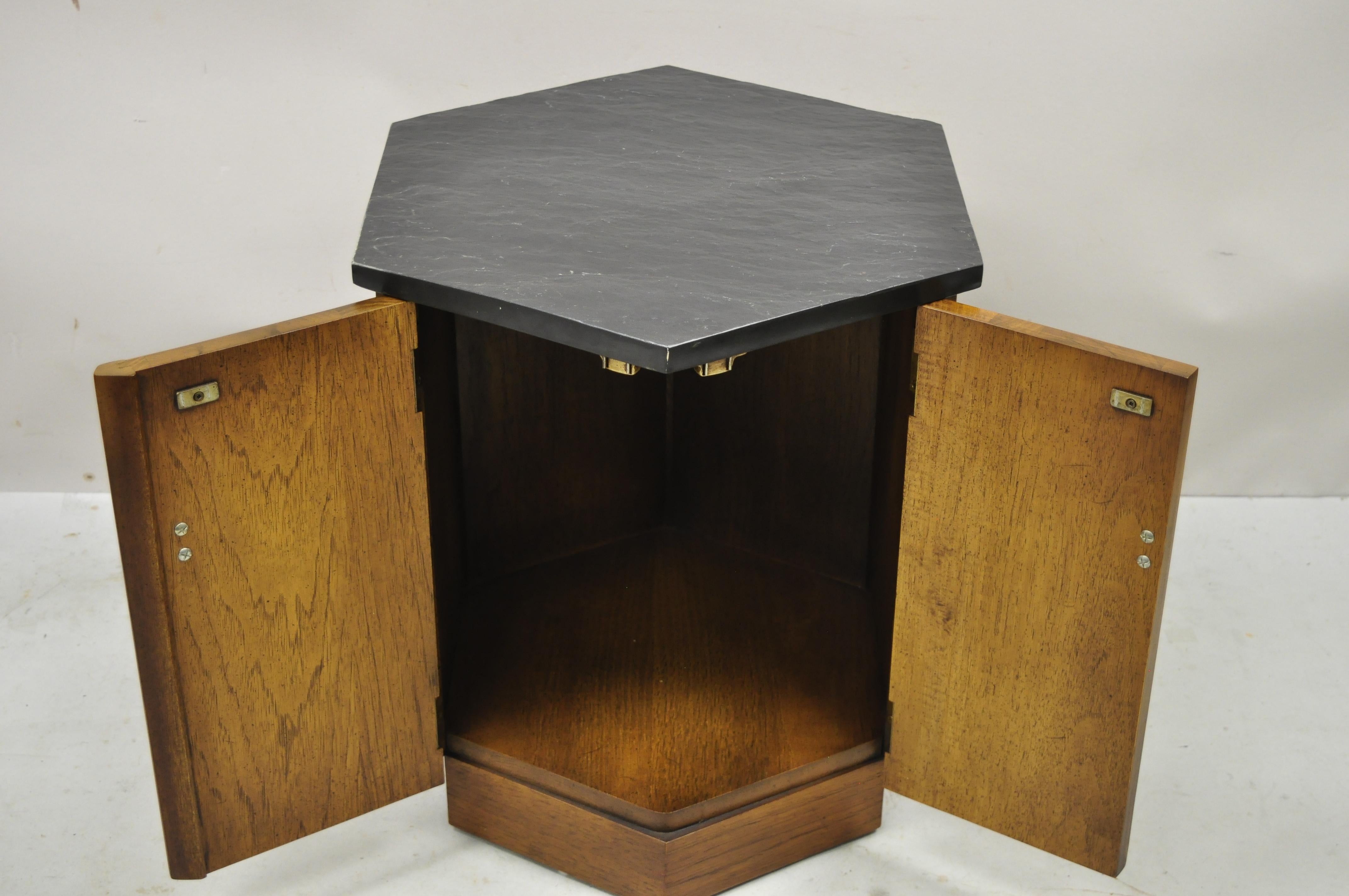 Mid-Century Modern walnut Hexagonal slate top side cabinet drum table. Item features hexagonal slate top, beautiful wood grain, finished back, 2 swing doors, very nice vintage item, great style and form. Circa mid 20th century. Measurements: 21