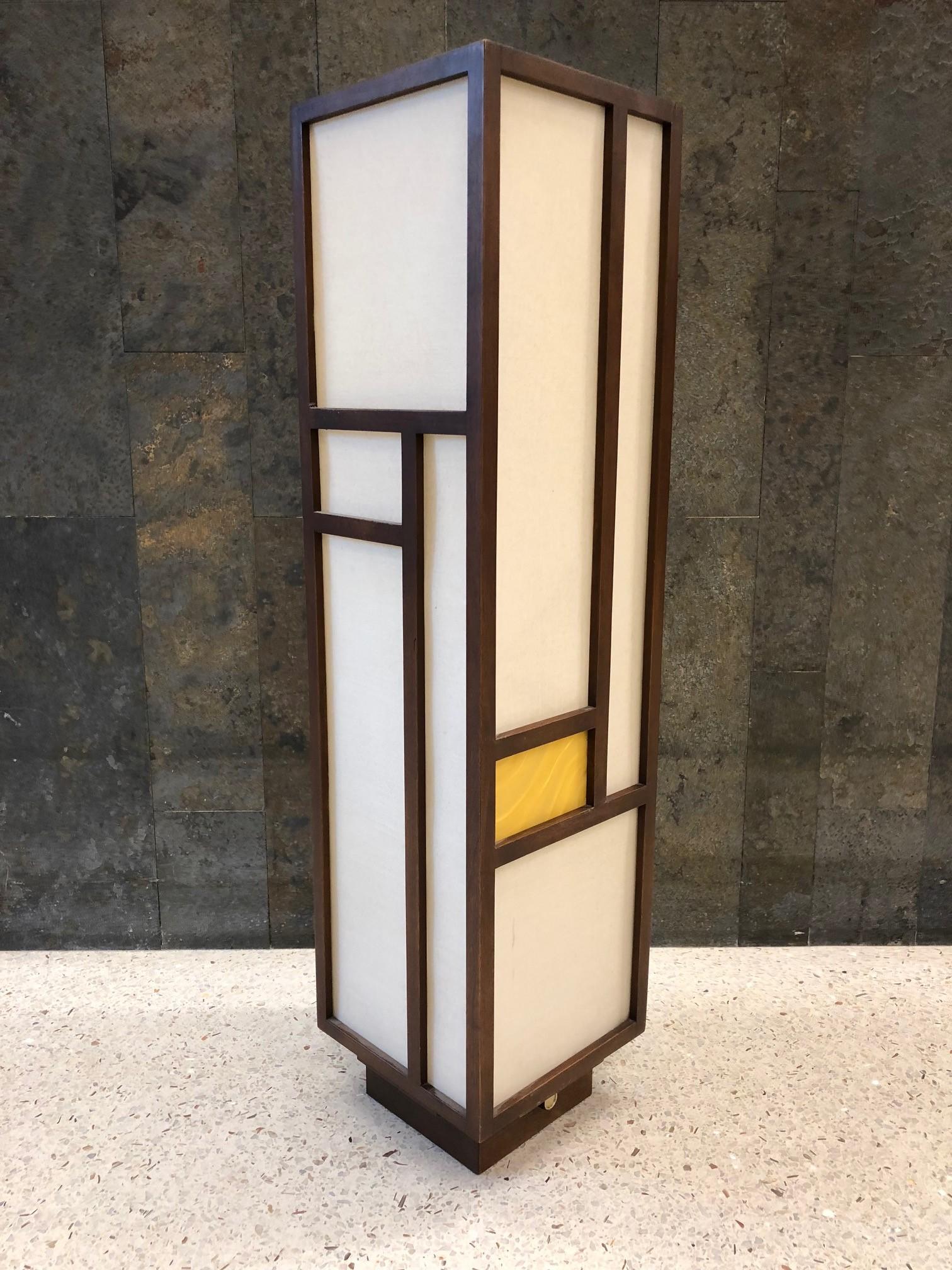 Mid-Century Modern lamp. The lamp has a solid walnut frame with linen and two gold acrylic panels. Beautiful when lit. Nakashima style. Has a dimmer switch.
