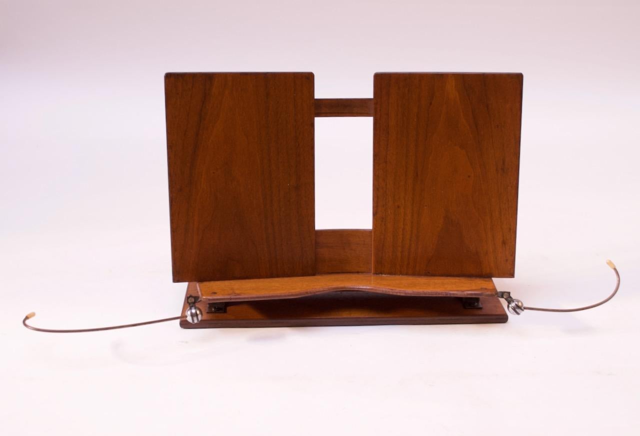 1960s wood lectern / bookstand in solid walnut with wire place holders and copper fittings, which mount the book holder to the base. The bookstand itself adjust forward and backwards for full flexibility.
Wear consistent with age / use present