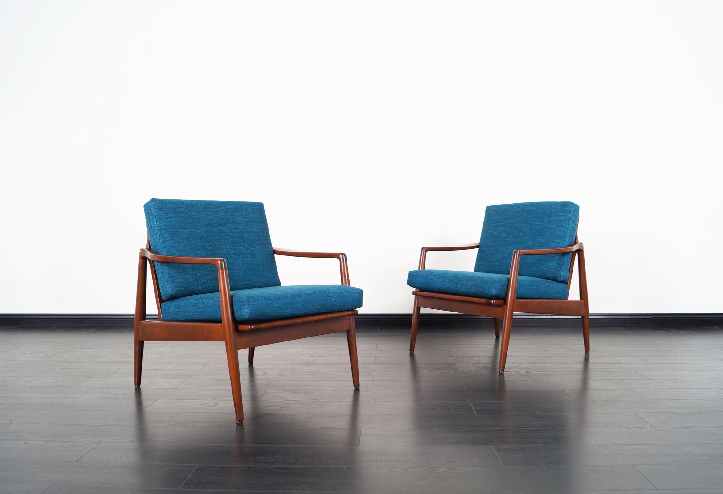 Mid-Century Modern walnut lounge chairs.