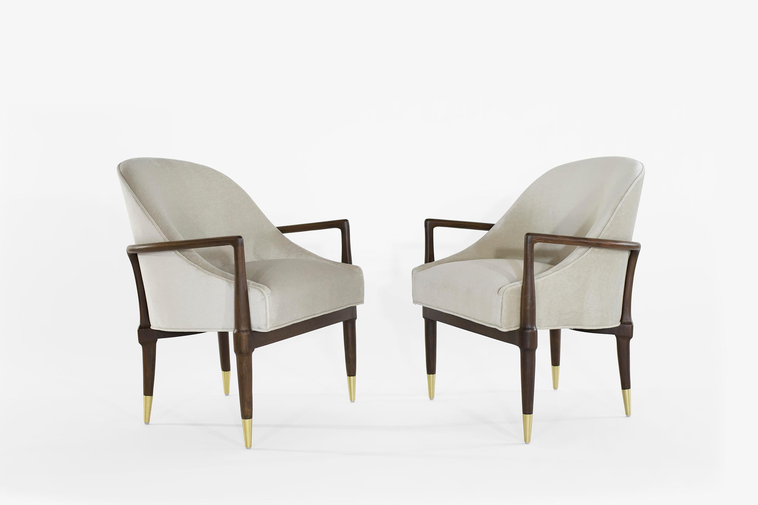 Pair of lounge chairs in the style of Gio Ponti, featuring completely restored sculptural walnut framing and brass sabots. Newly upholstered in grey velvet.