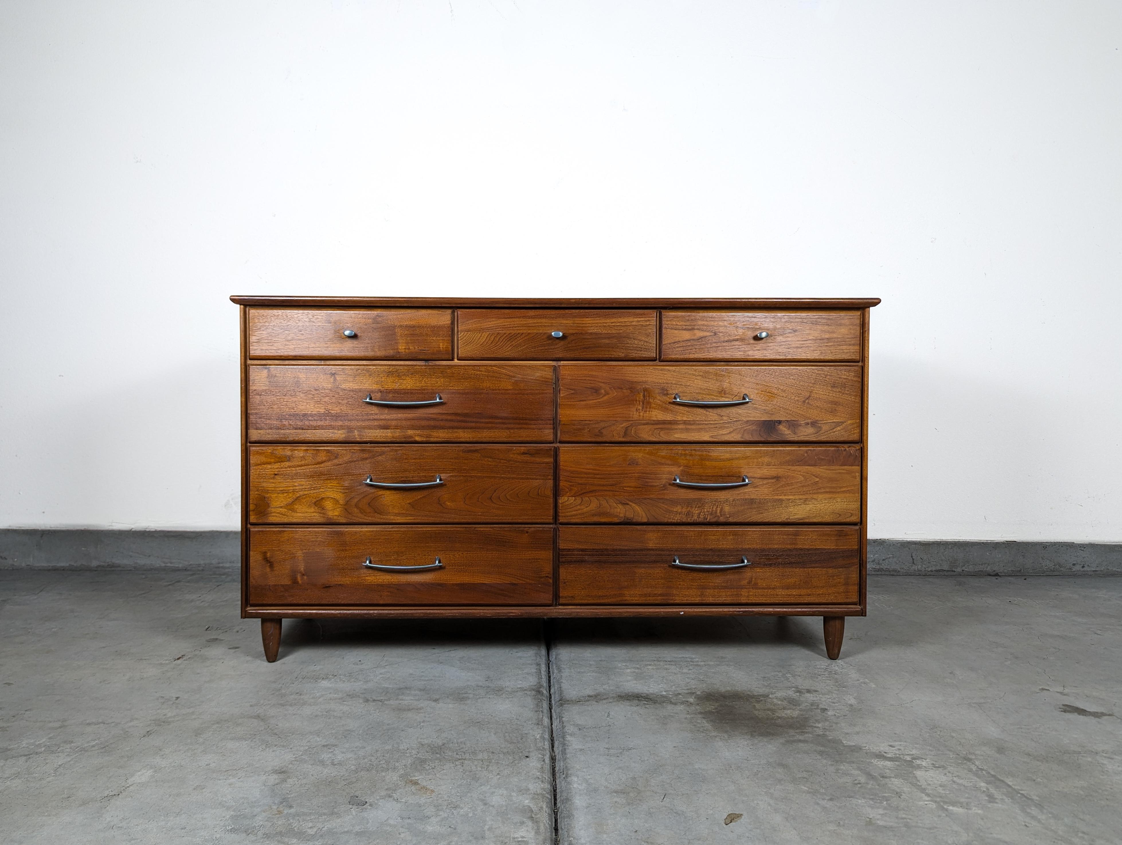 Discover the epitome of mid-century design with this exquisite vintage walnut dresser by Ace-Hi, crafted in the vibrant 1960s. This dresser represents a true testament to the era's dedication to quality and style, with its solid walnut construction