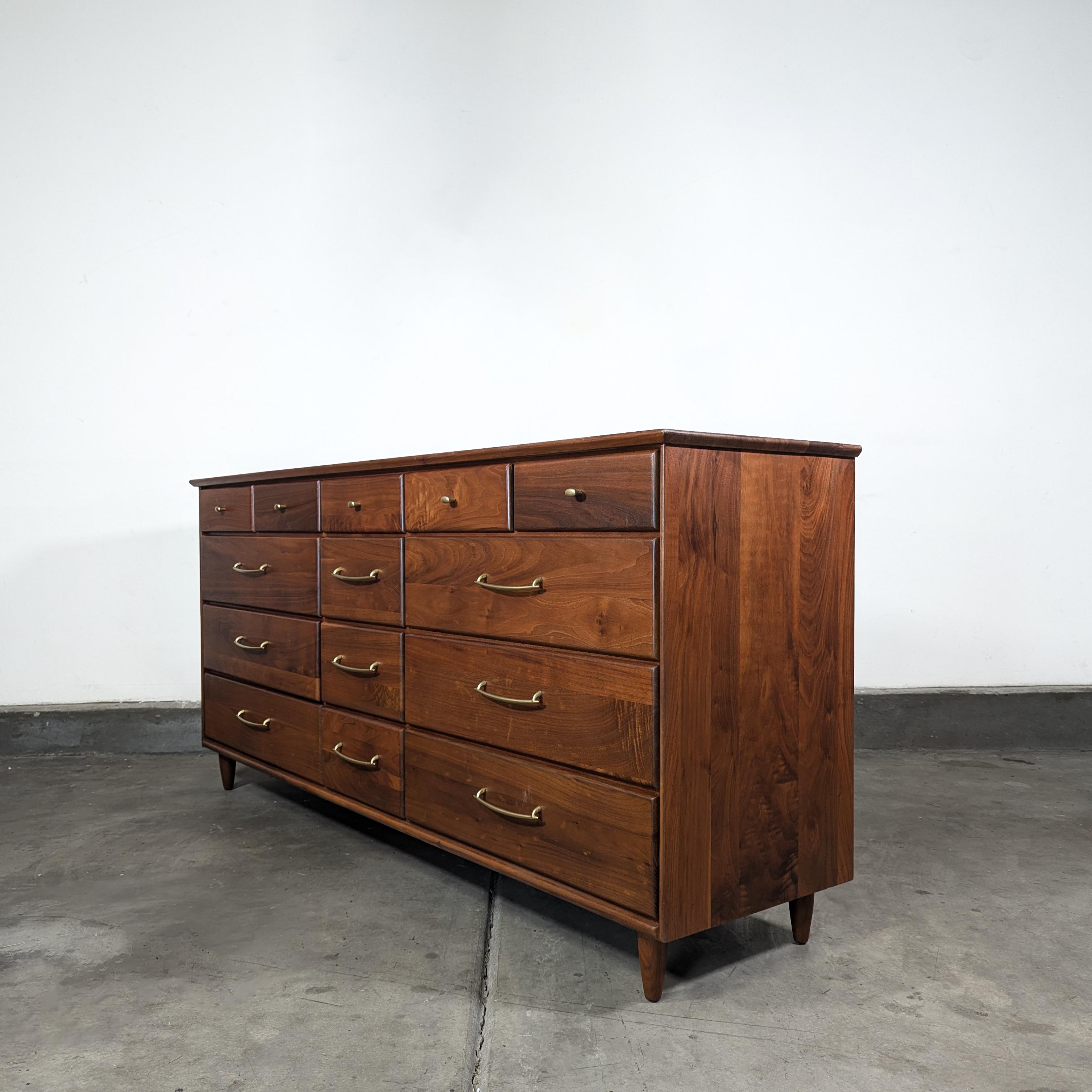 Discover the epitome of mid-century design with this exquisite vintage walnut dresser by Ace-Hi, crafted in the vibrant 1960s. This dresser represents a true testament to the era's dedication to quality and style, with its solid walnut construction