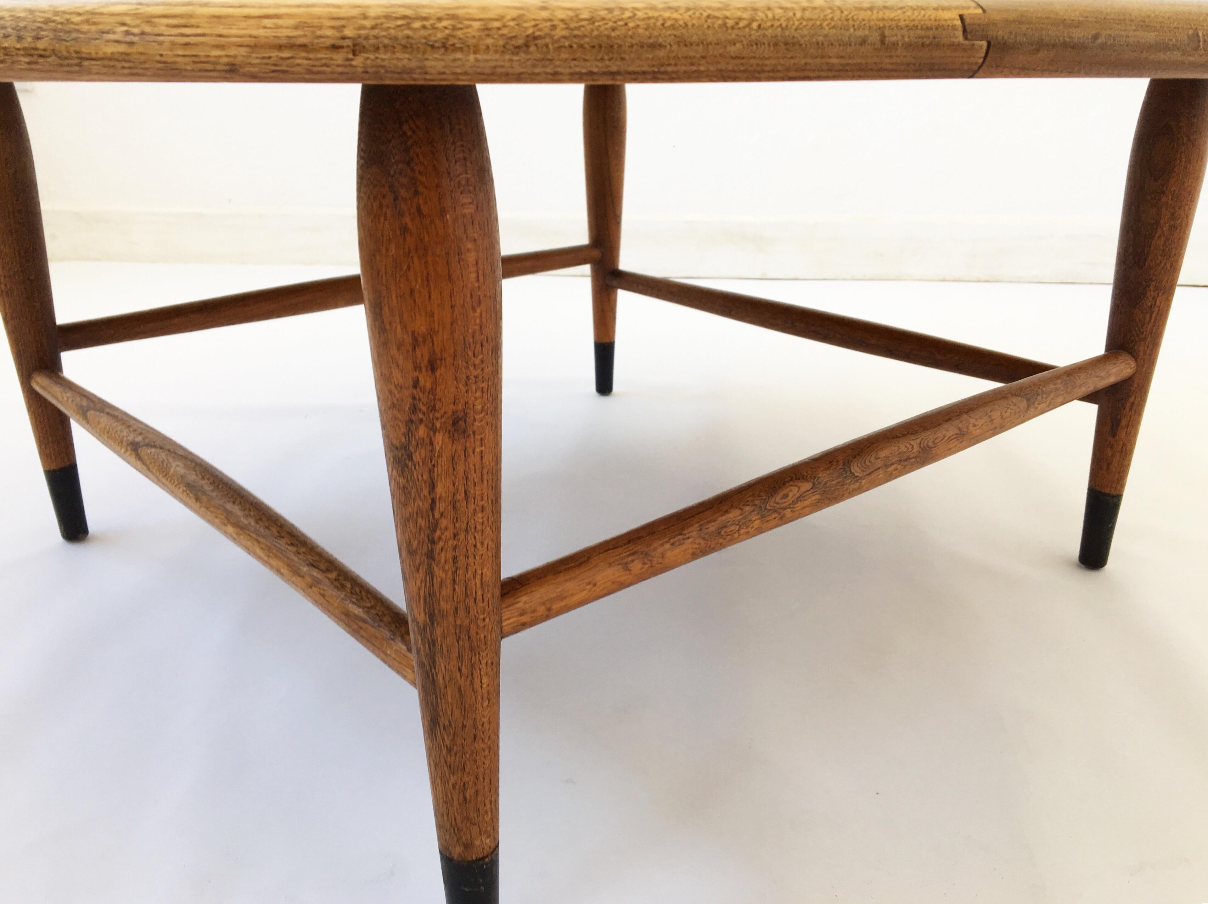 Exquisite American modern walnut coffee table designed by Andre Bus for Lane's Acclaim series, circa 1960, with metal tipped dowel legs and dovetail feature on the table top.