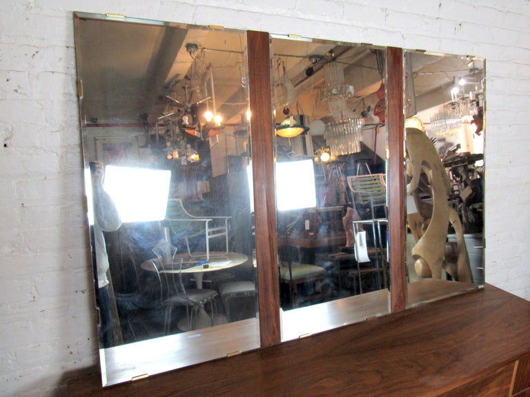 A large vintage mirror with three panels and walnut dividers between the mirror panels. A large and impressive mirror perfect for any interior setting. Please confirm item location with seller (NY/NJ).