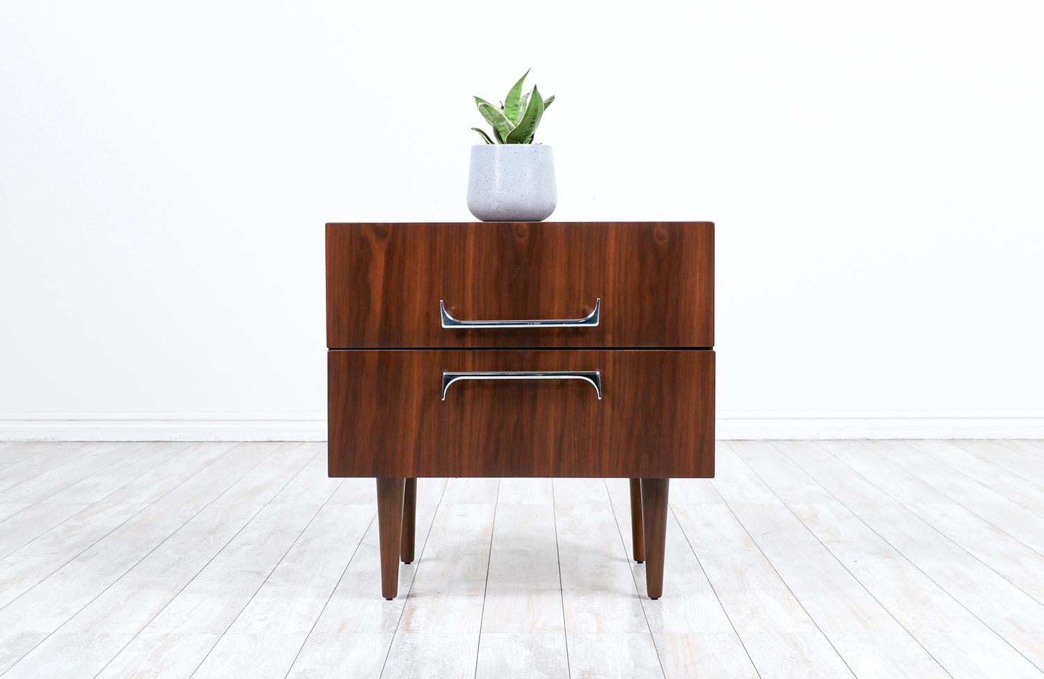 Mid-Century Modern walnut night stand with sculpted chrome pulls.