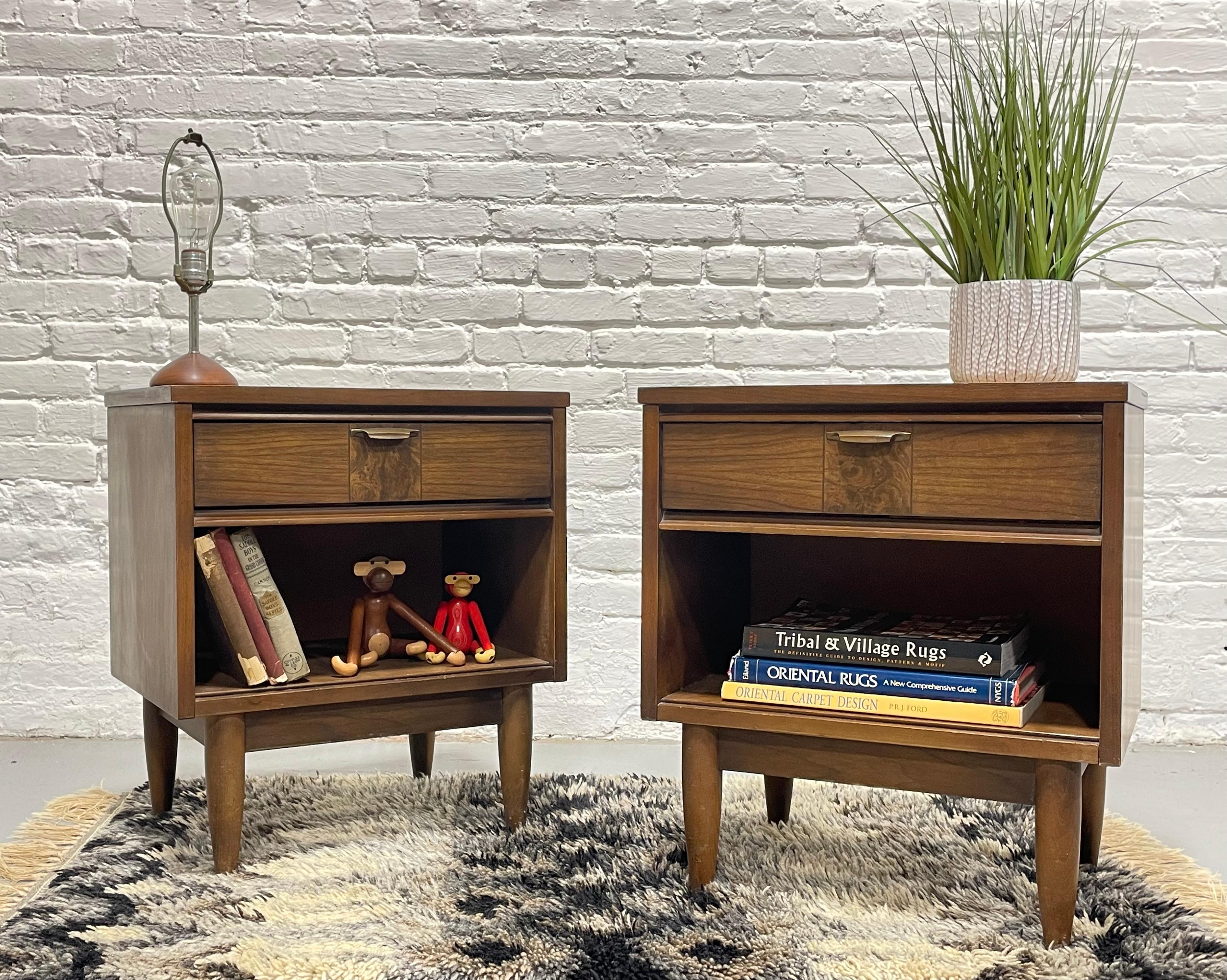Pair of Mid Century Modern Walnut Nightstands, c. 1960's. This lovely pair offers a single dovetailed drawer and open area below, perfect for your bedtime essentials as well as showcasing design objects or books below. The drawer front features a