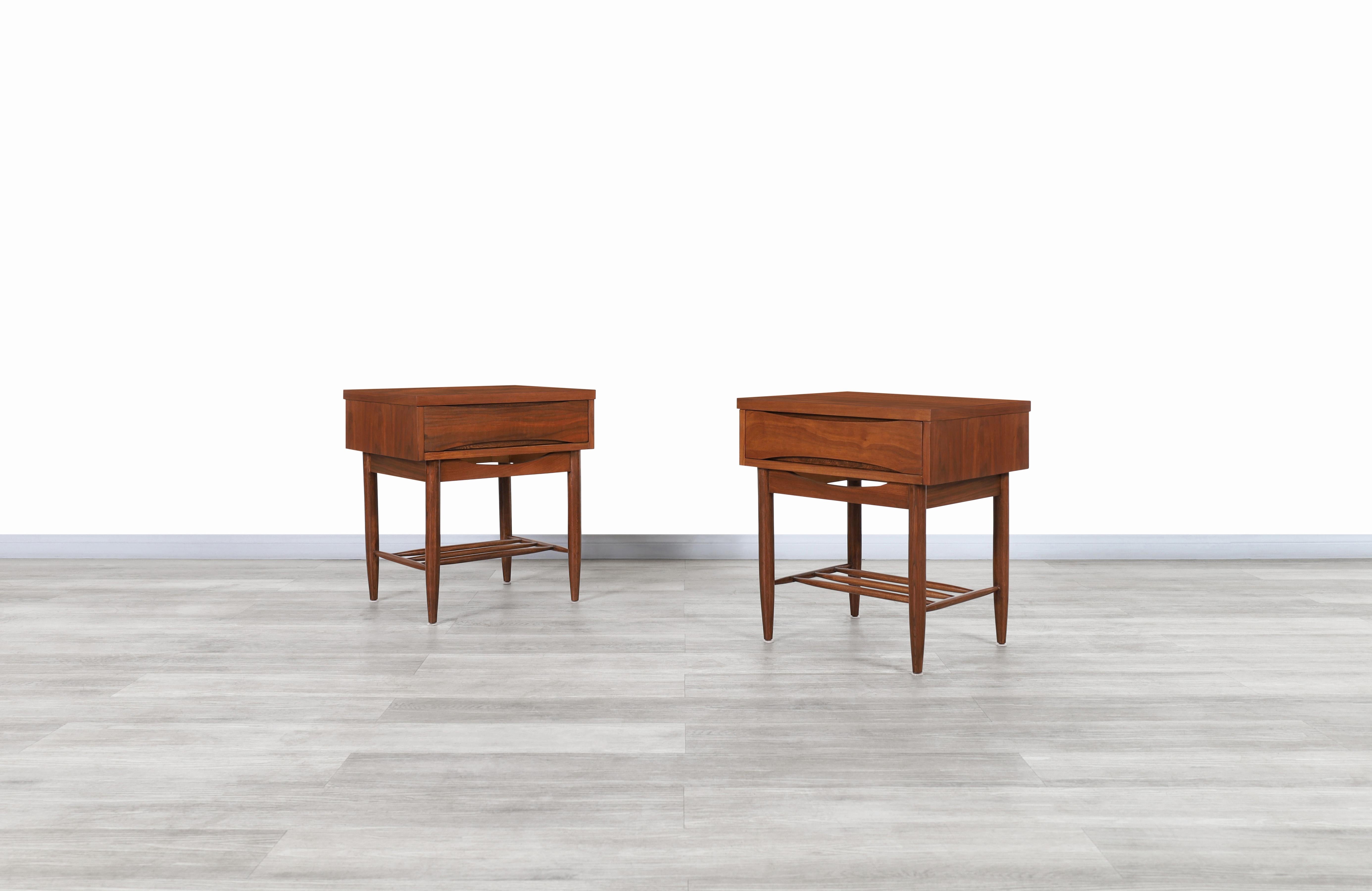 Fabulous Mid-Century Modern walnut nightstands designed by Broyhill and manufactured by United States, circa 1960s. These nightstands have been constructed from the highest quality walnut wood and feature a Minimalist yet highly functional design.