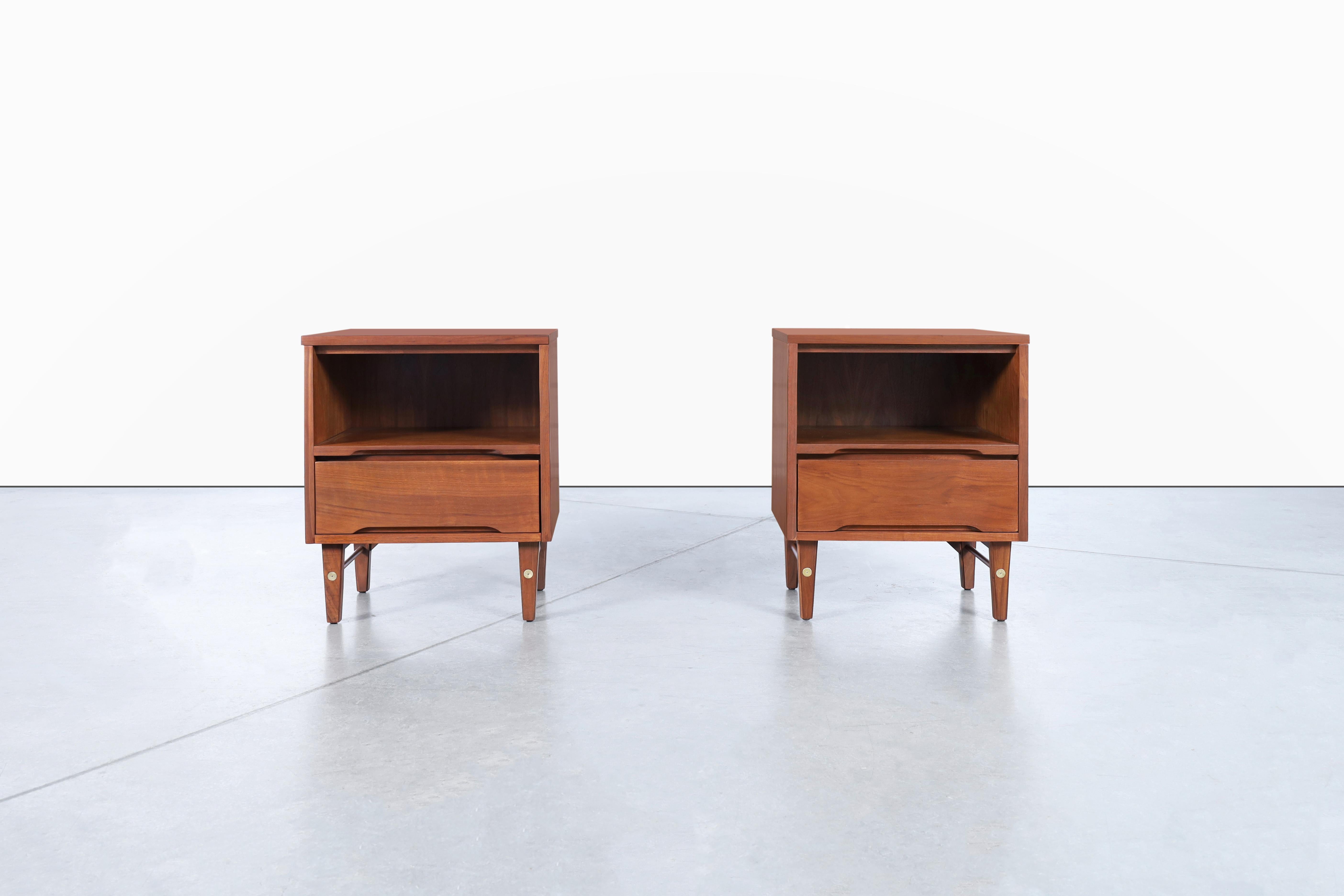 This set of mid-century modern walnut nightstands by Stanley Furniture is a true gem from the 1950s. Crafted from high-quality walnut, they have been refinished to restore their original beauty. Each nightstand features a single dovetail drawer with